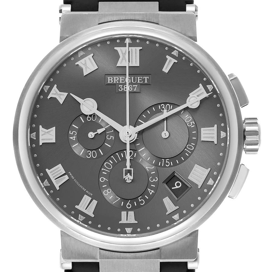 The Breguet Marine watch is shown from a front angle, highlighting its dial, hands, subdials, and crown.