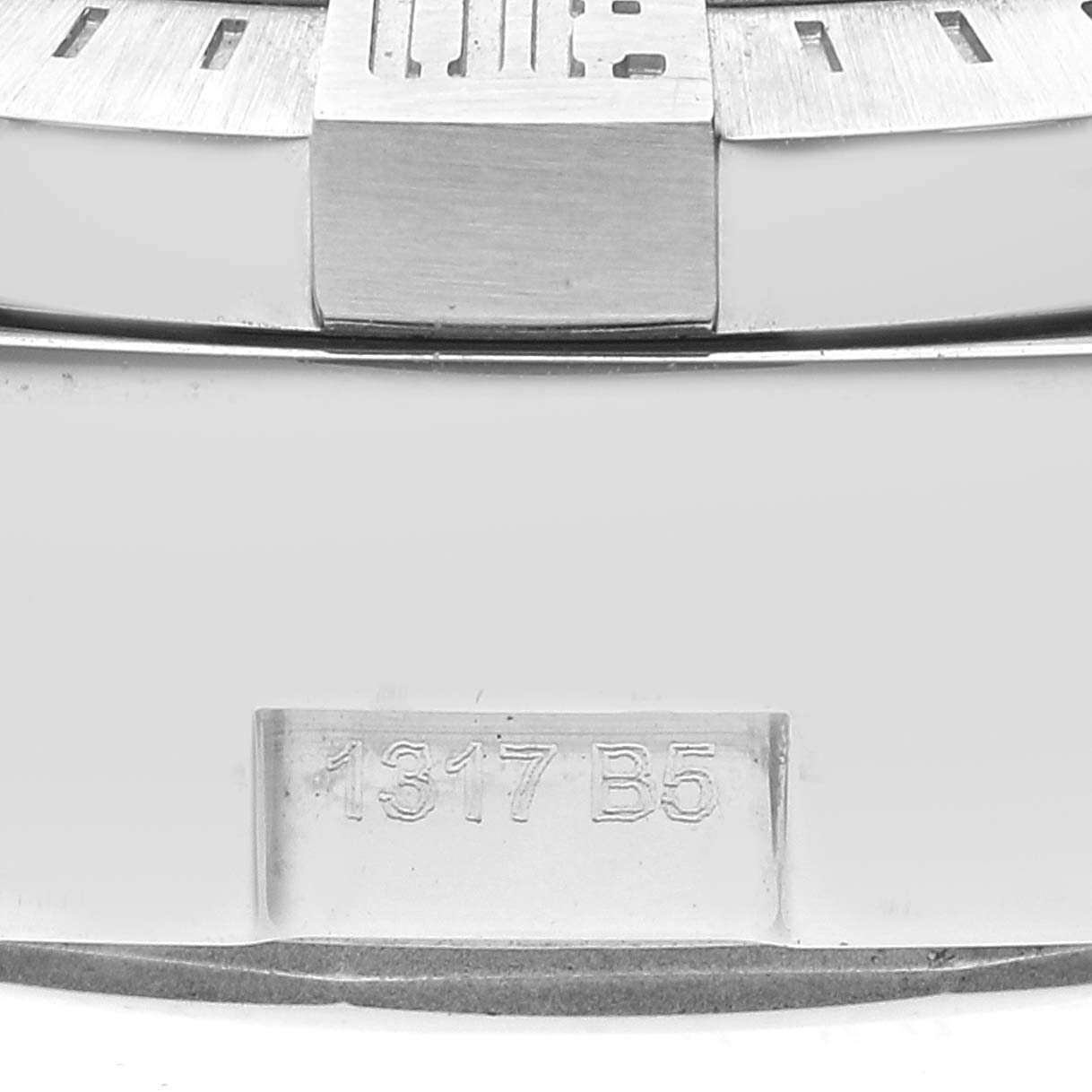 Close-up view of the side of a Breitling Avenger A13381 Men's Stainless Steel Black Dial A13381 Men's Stainless Steel Black Dial watch, showing the bezel and a serial number engraving.