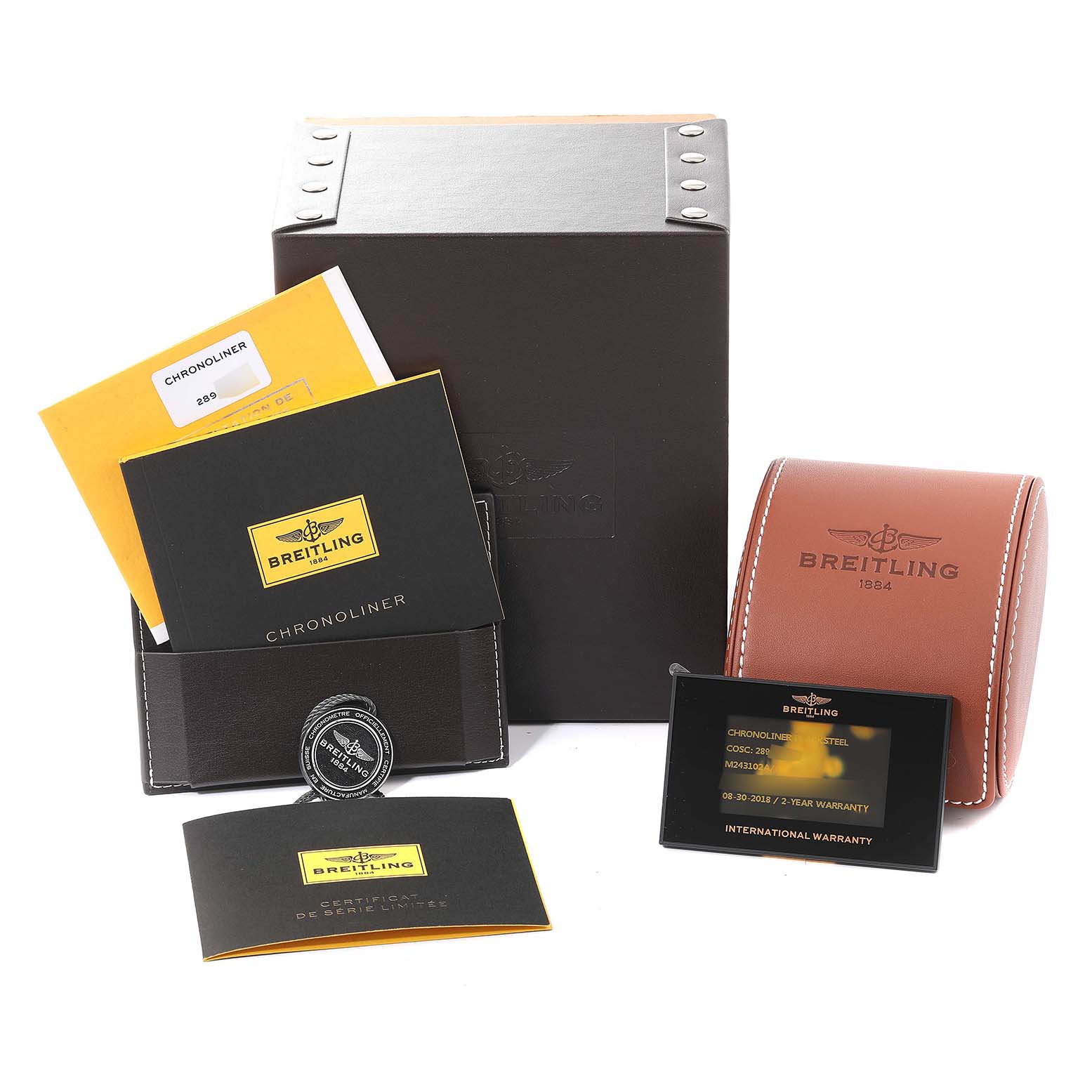The image shows the Breitling Chronoliner M24310 Men's Stainless Steel Black Dial M24310 Men's Stainless Steel Black Dial watch box, instruction booklets, warranty card, and a leather watch case from a front angle.