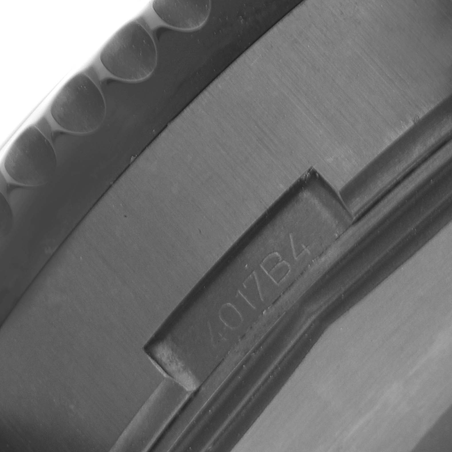 The image shows a close-up view of the bezel and part of the case of a Breitling Chronoliner M24310 Men's Stainless Steel Black Dial M24310 Men's Stainless Steel Black Dial watch.