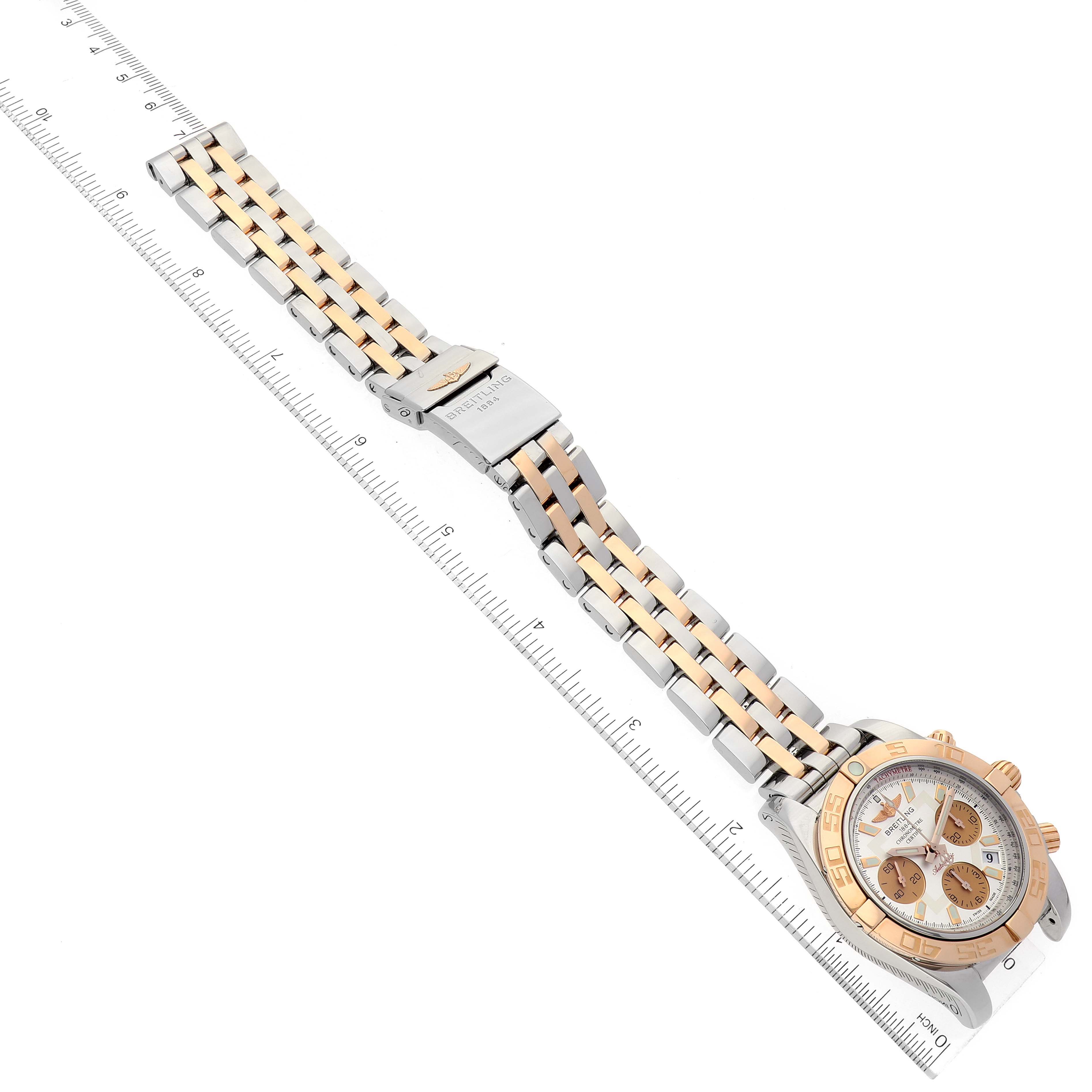 The Breitling Chronomat CB014012/G713 Men's Steel and Gold (two tone) Silver Dial CB014012/G713 Men's Steel and Gold (two tone) Silver Dial watch is shown at an oblique angle, displaying the dial, bezel, case, bracelet, and clasp.