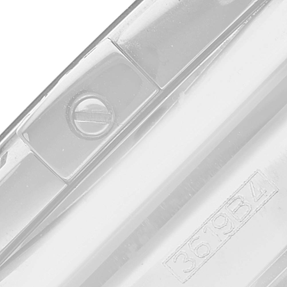 This image shows a close-up of the side of a Breitling Chronomat AB0115 Men's Stainless Steel Brown Dial AB0115 Men's Stainless Steel Brown Dial watch, highlighting the screw and model number.