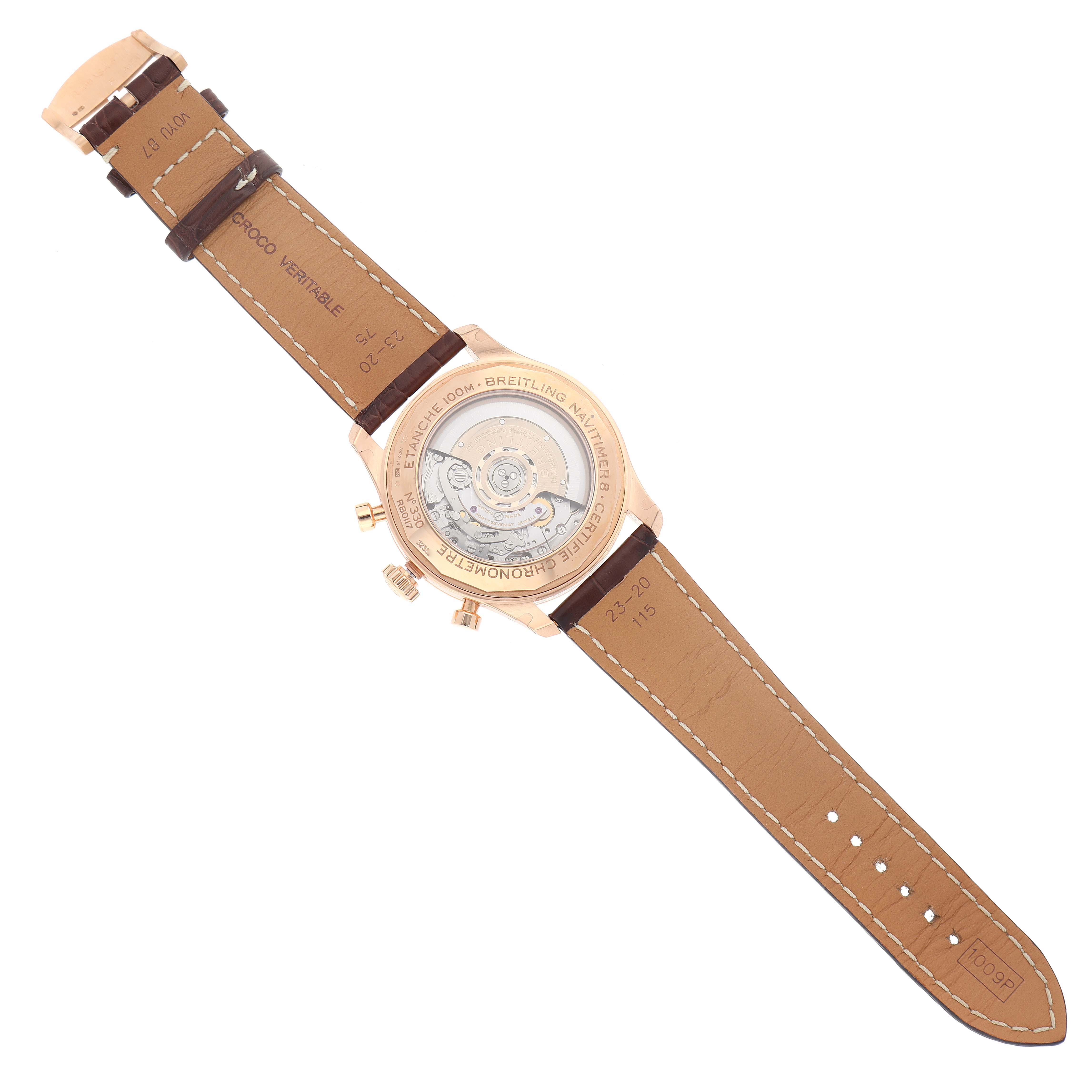 The image shows the back view of a Breitling Navitimer watch, highlighting its transparent case back and leather strap.