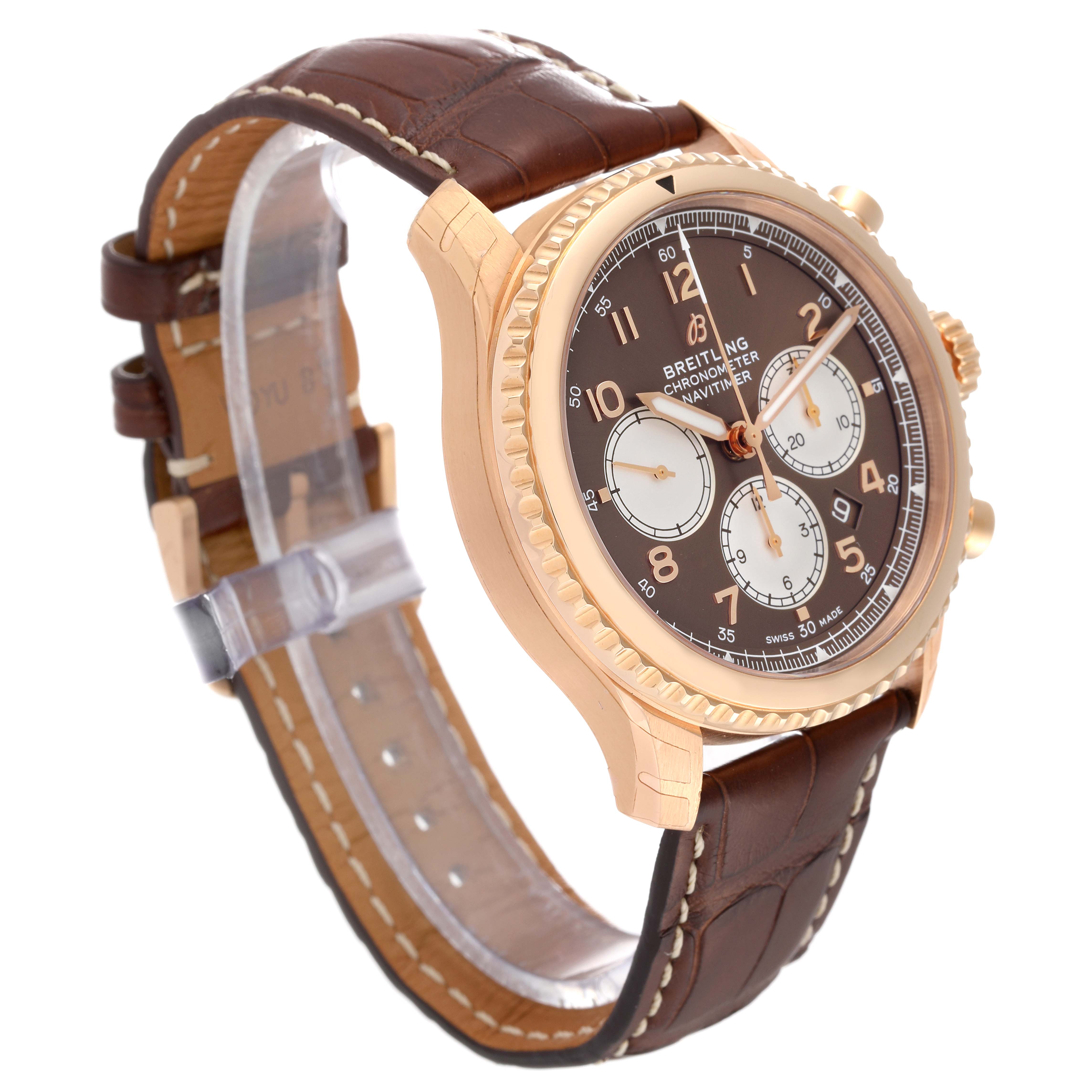 The image shows a side angle view of a Breitling Navitimer watch, highlighting its brown dial, gold case, and brown leather strap.