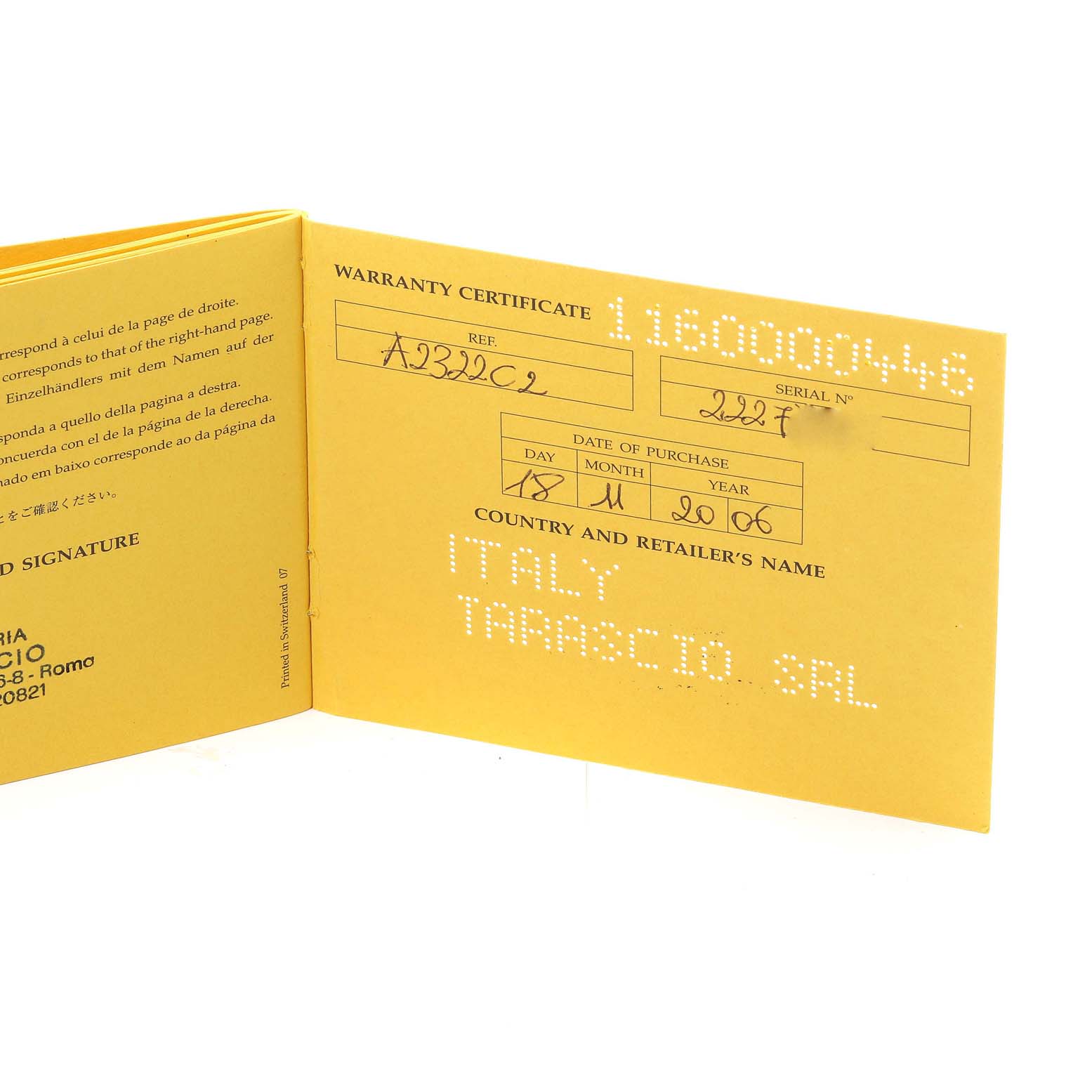 The image shows a yellow warranty certificate for a Breitling Navitimer A23322 Men
s Stainless Steel Black Dial A23322 Men
s Stainless Steel Black Dial watch, including reference and serial numbers.