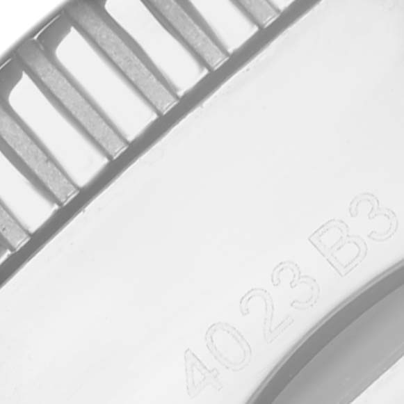 The image shows a close-up of the bezel and part of the case of a Breitling Superocean A13313 Men's Stainless Steel Green Dial A13313 Men's Stainless Steel Green Dial watch, featuring ridges and engravings.