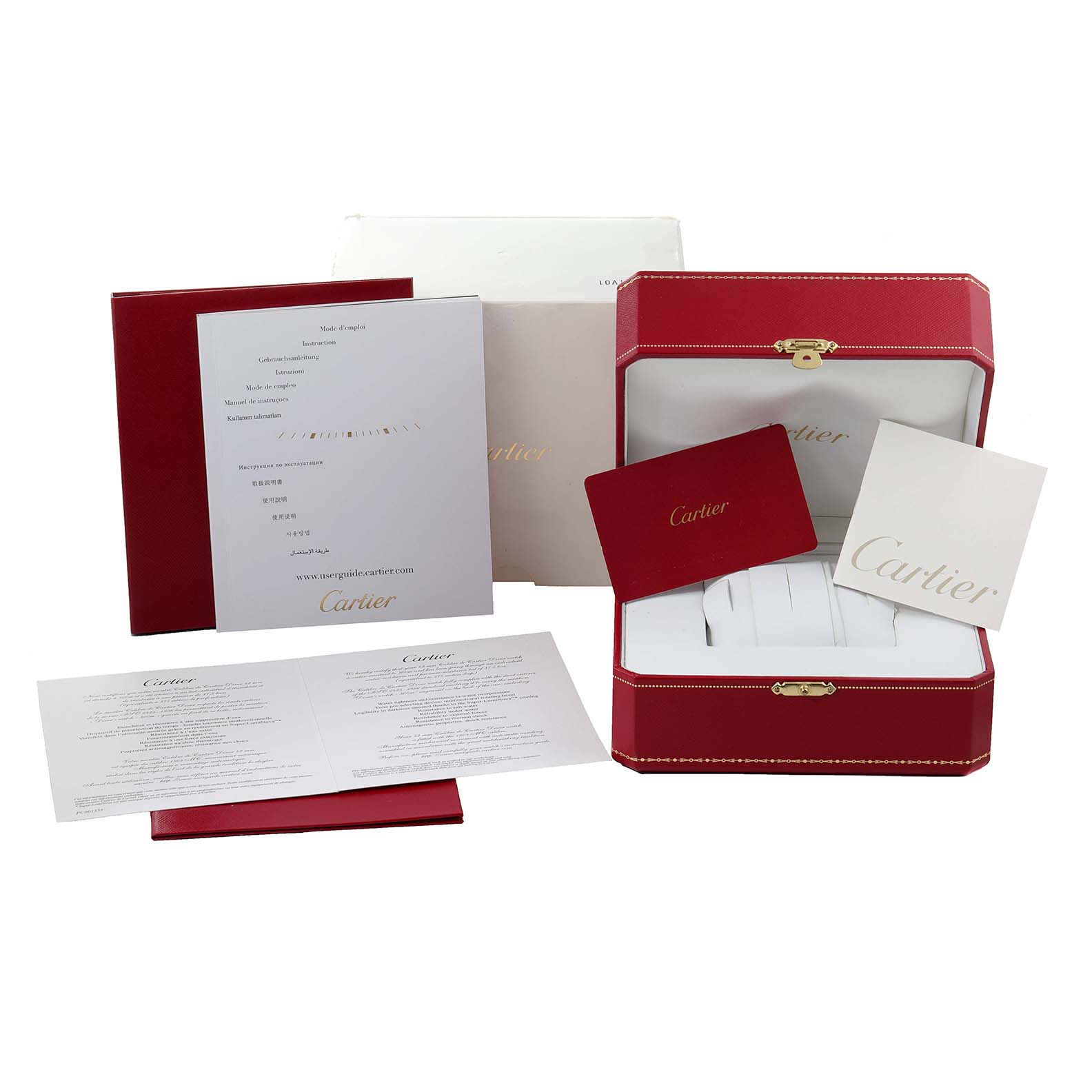 This image shows the packaging and accessories for a Calibre de Cartier model by Cartier, including a red box, booklets, and documents.