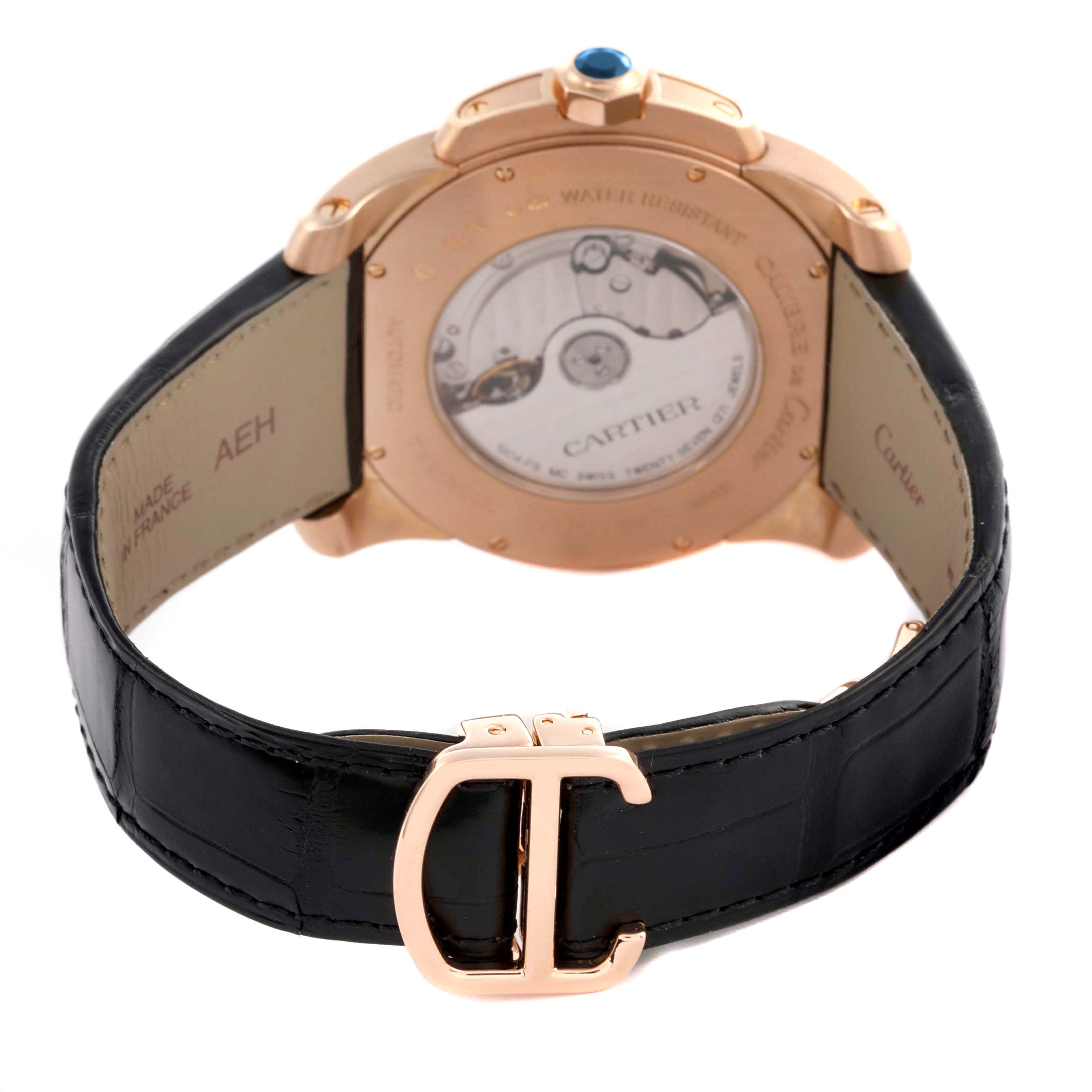 The image shows the back of a Calibre de Cartier watch, highlighting the open case back and leather strap with a Cartier clasp.
