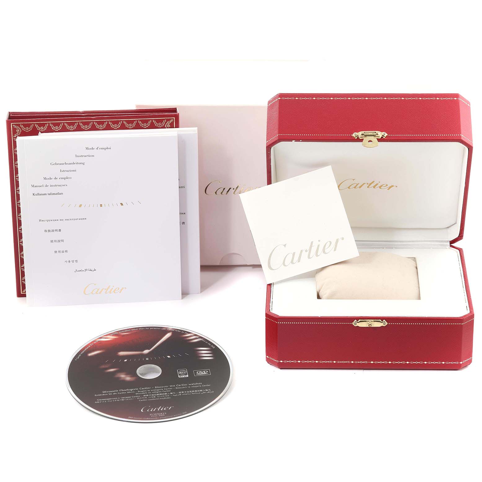 The image shows the packaging and accessories of a Cartier Pasha W31077M7 Men's Stainless Steel Black Dial W31077M7 Men's Stainless Steel Black Dial watch, including a watch box, booklets, and a CD.