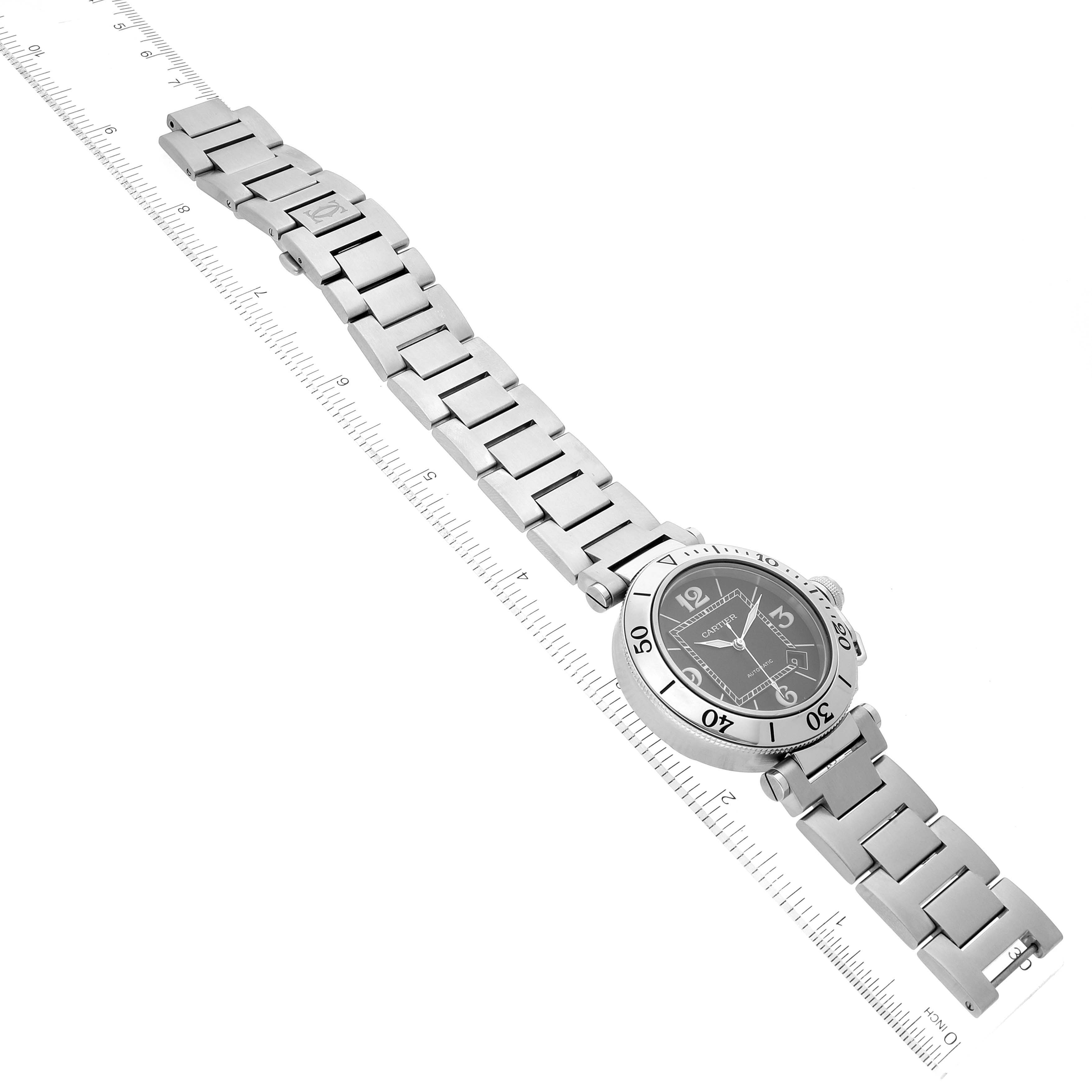 This image shows a flat-lay view of the Cartier Pasha W31077M7 Men's Stainless Steel Black Dial W31077M7 Men's Stainless Steel Black Dial model watch with its full metal bracelet and the dial visible.