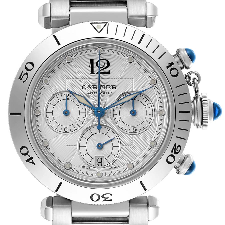 The Cartier Pasha watch is shown from a front angle, highlighting its dial, bezel, and crown with blue cabochons.