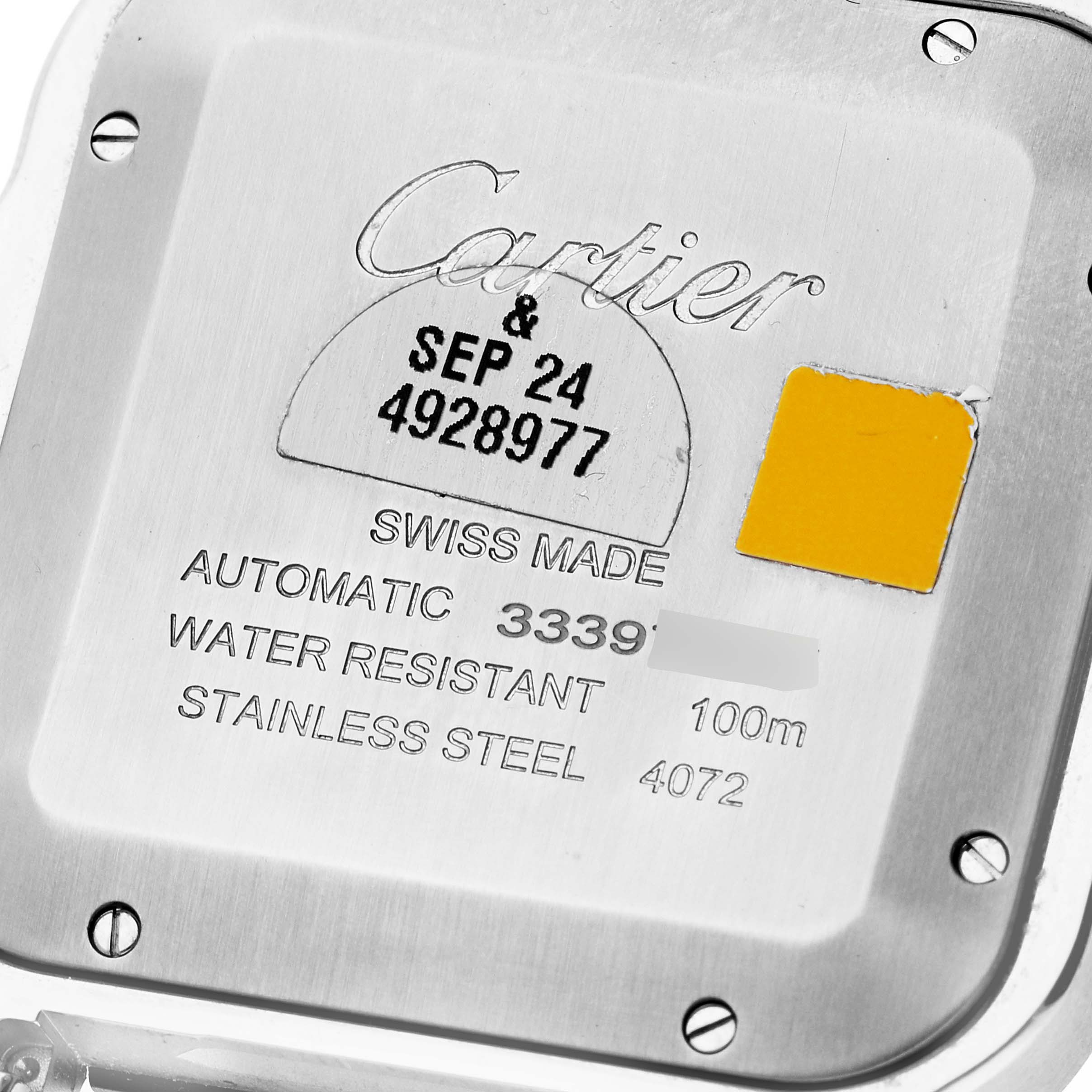 The image shows the back case of a Santos de Cartier watch, highlighting the engraved specifications.