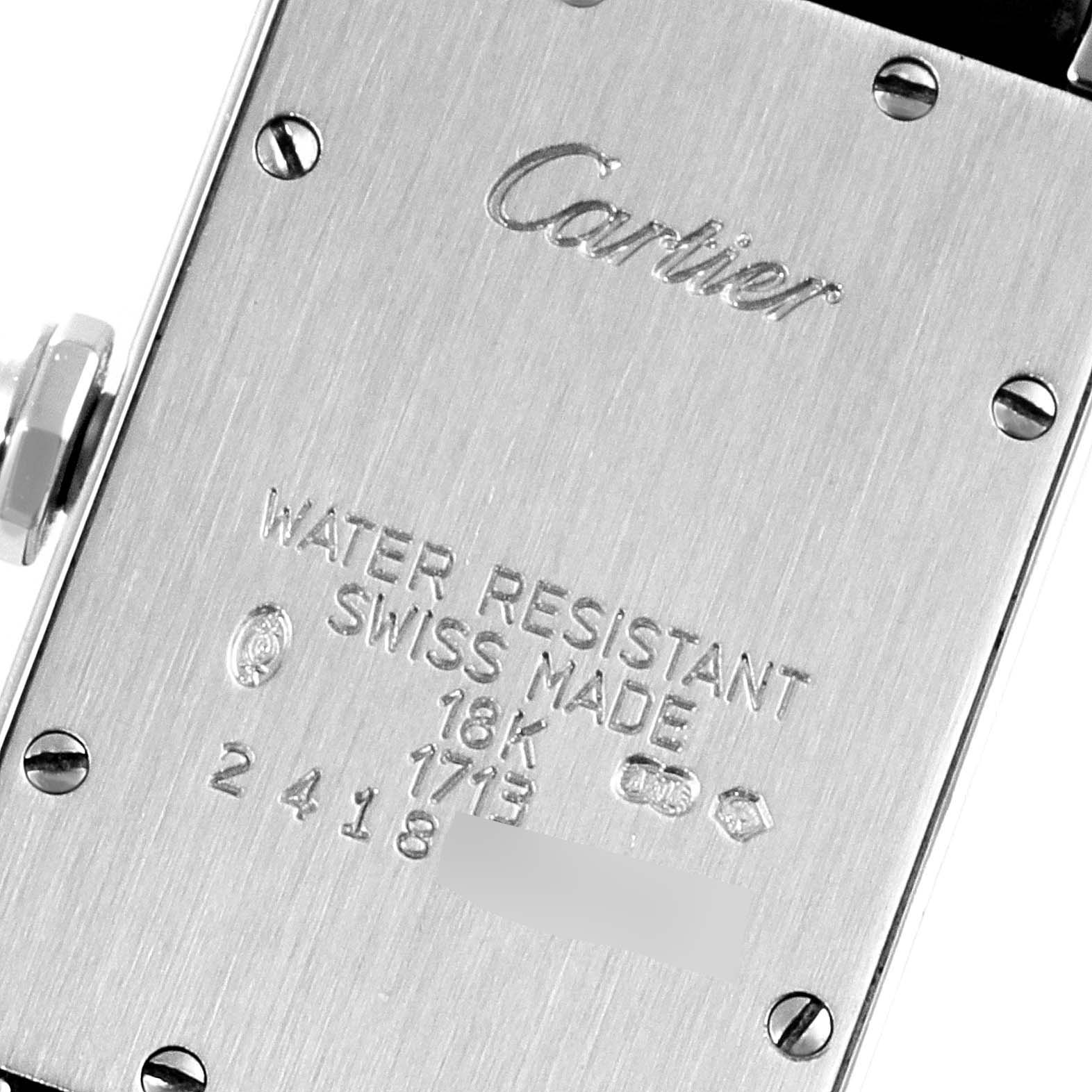 The image shows the back case of a Cartier Tank Americaine W2605129 Women's White Gold Grey Dial W2605129 Women's White Gold Grey Dial watch, highlighting its inscriptions and screws.