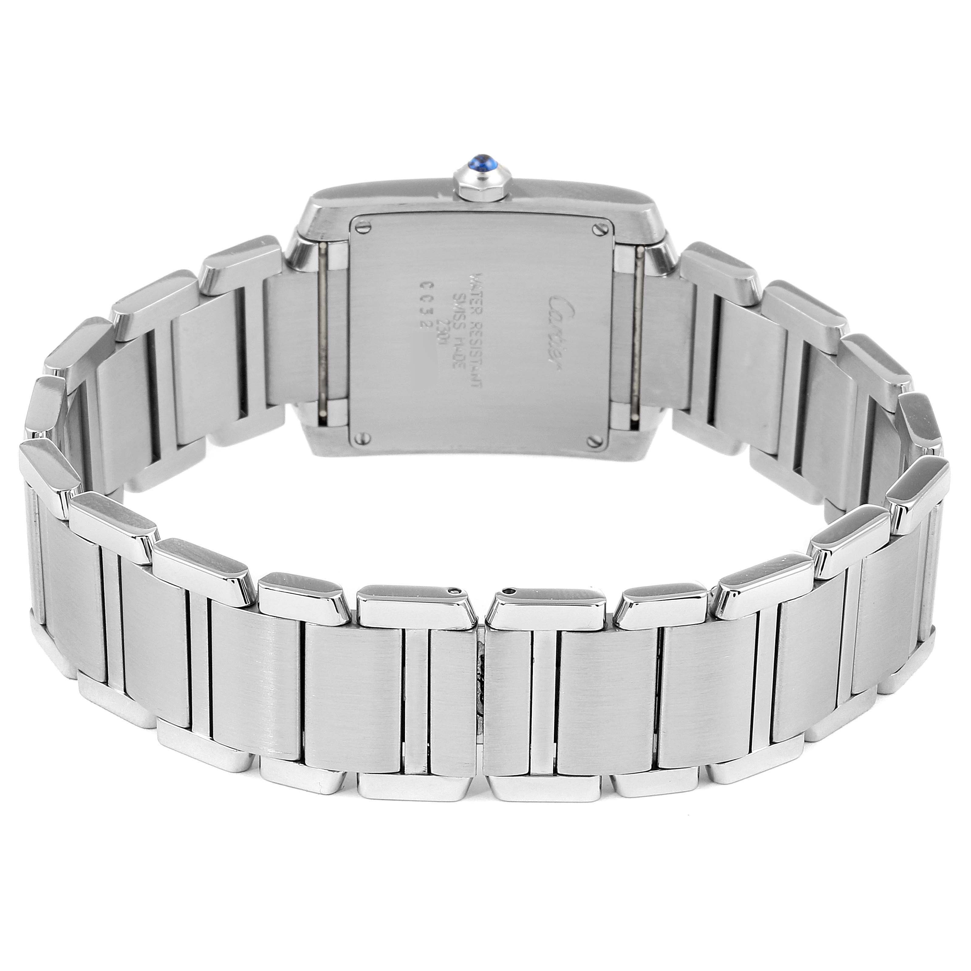 The image shows the back of the Cartier Tank Française watch, highlighting its metal bracelet and case back.