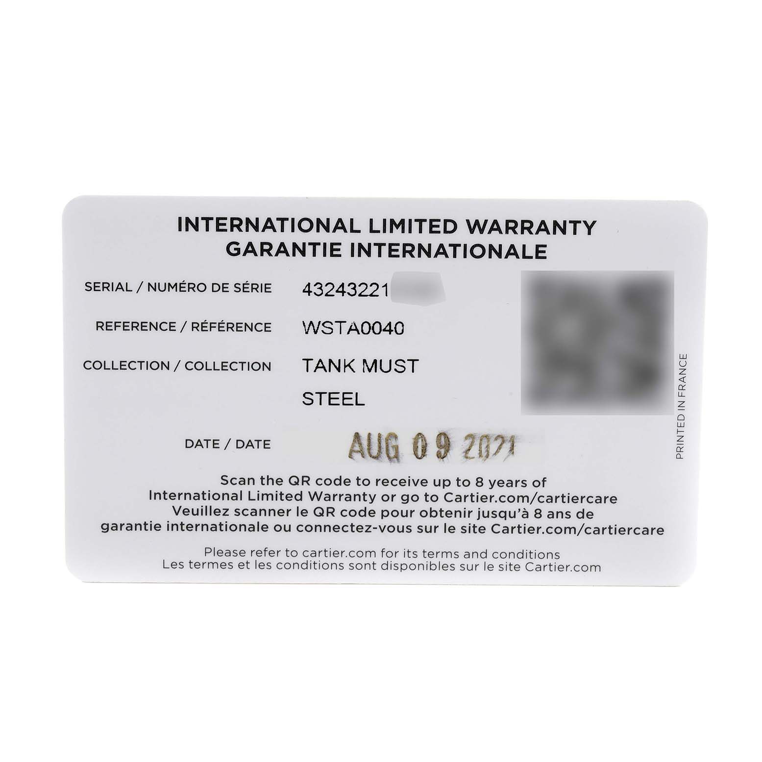 This image shows an International Limited Warranty card for the Cartier Tank Must WSTA0040 Men's Stainless Steel Silver Dial WSTA0040 Men's Stainless Steel Silver Dial model, including serial, reference number, and purchase date.