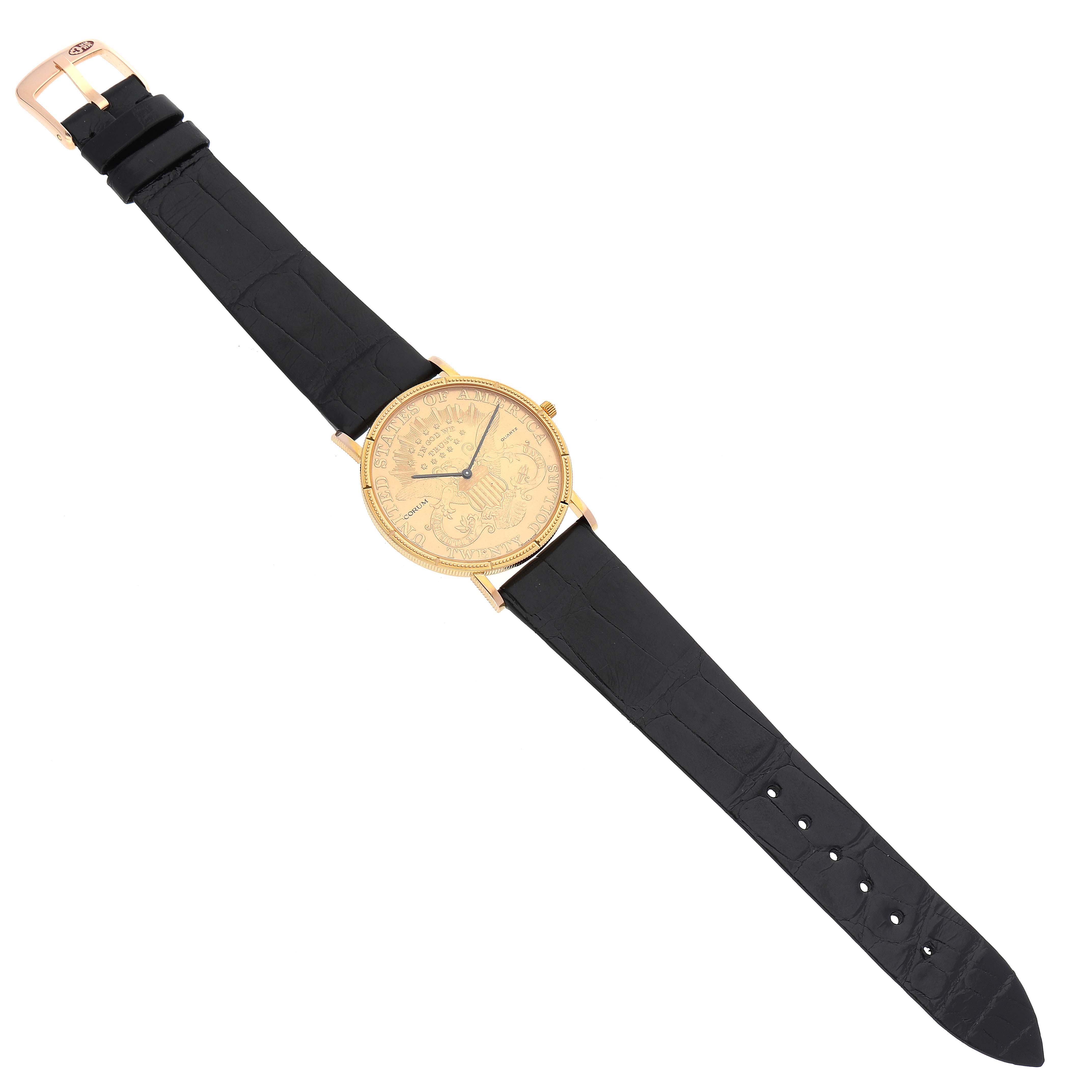 The Coin Watch by Corum is shown from a top-down angle, displaying the full watch including its gold case and black leather strap.