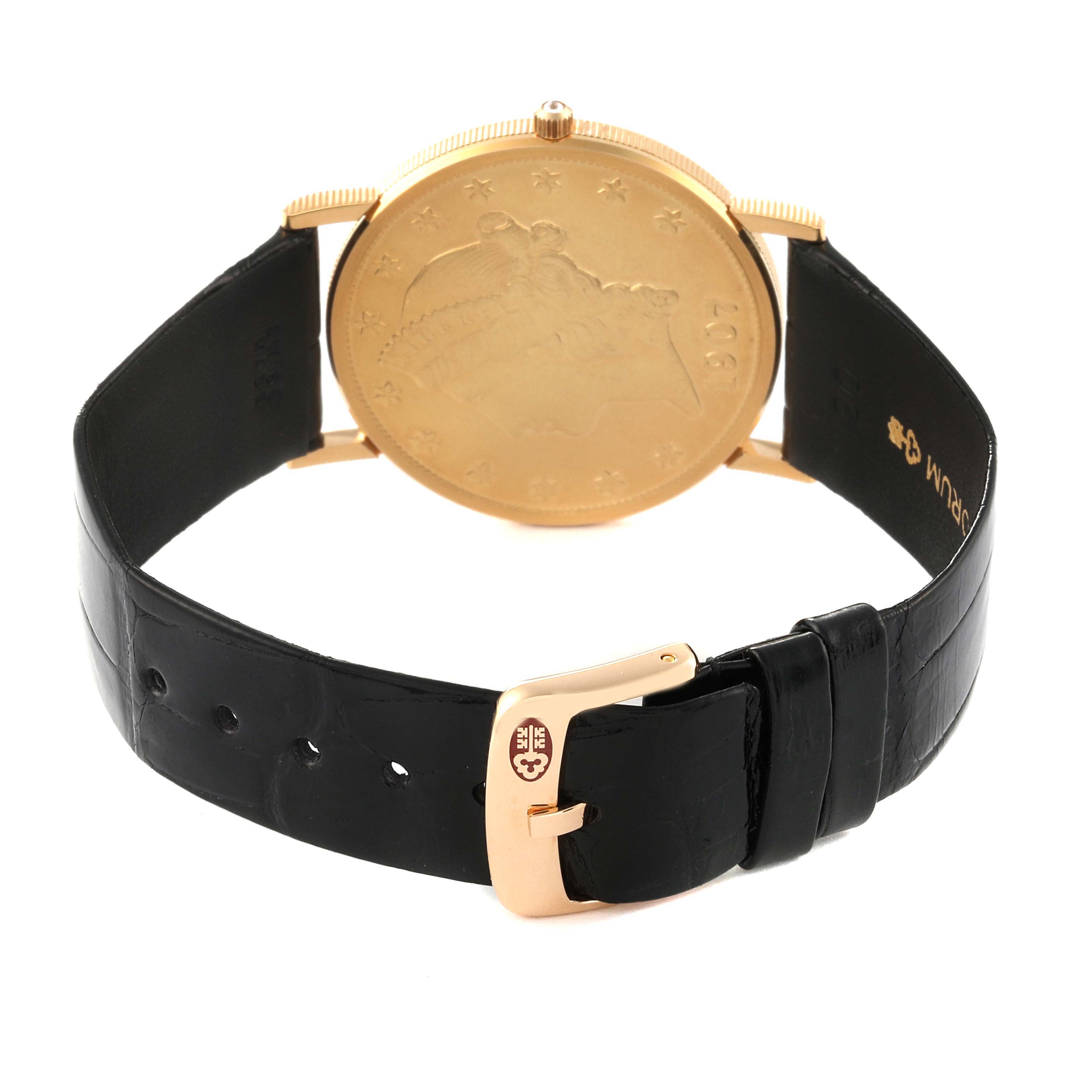 This image shows the back of a Corum Coin Watch 1907 Men's Yellow Gold Champagne Dial 1907 Men's Yellow Gold Champagne Dial model, highlighting its golden case and black leather strap.