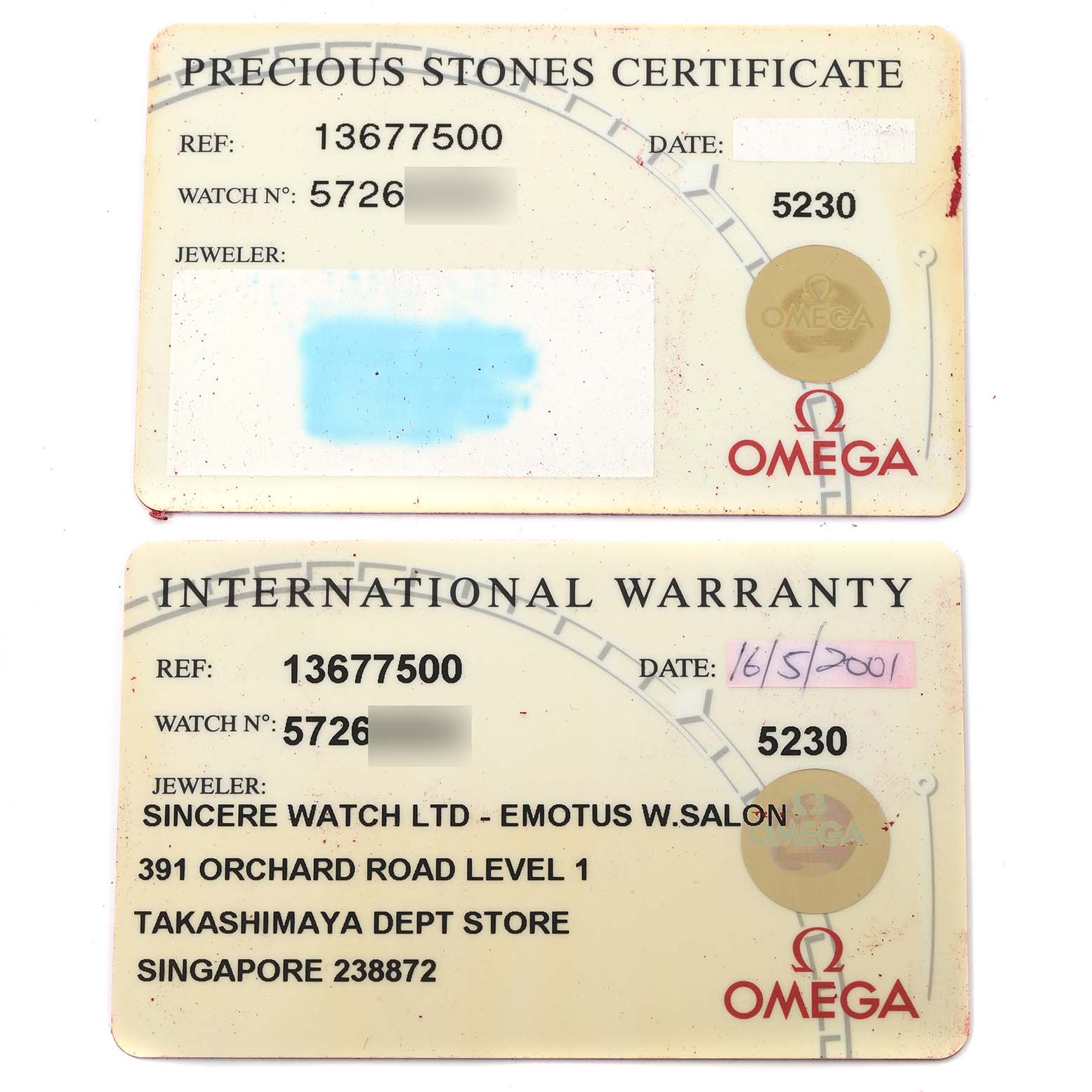 The image shows the Precious Stones Certificate and International Warranty cards for the Omega 1367.75.00 Women
s Steel and Gold (two tone) Mother of Pearl Dial 1367.75.00 Women
s Steel and Gold (two tone) Mother of Pearl Dial Constellation Steel Yellow Gold Diamond Ladies 1367.75.00.