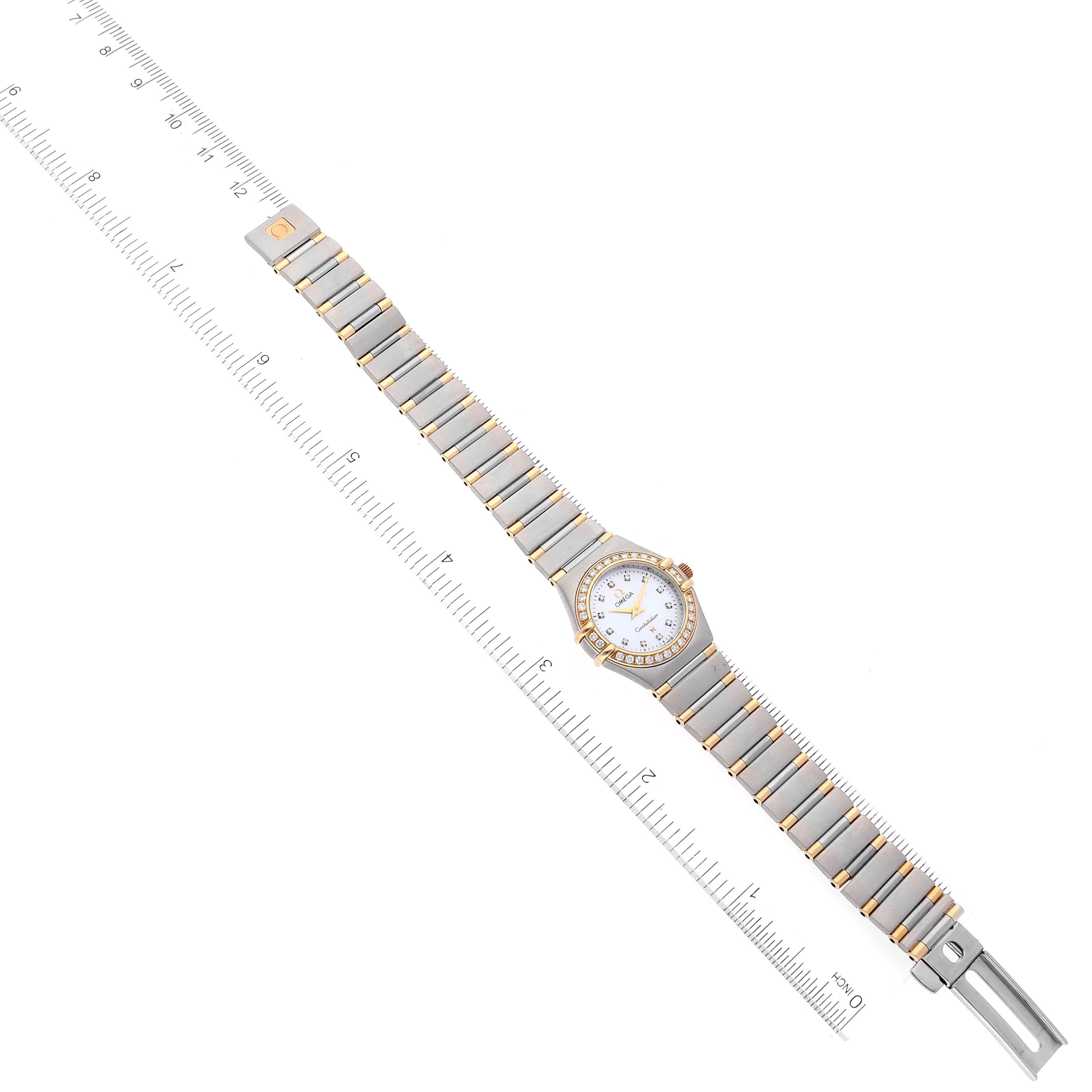 The Omega 1367.75.00 Women
s Steel and Gold (two tone) Mother of Pearl Dial 1367.75.00 Women
s Steel and Gold (two tone) Mother of Pearl Dial Constellation 1367.75.00 watch is shown fully extended from a top view with a ruler for scale.