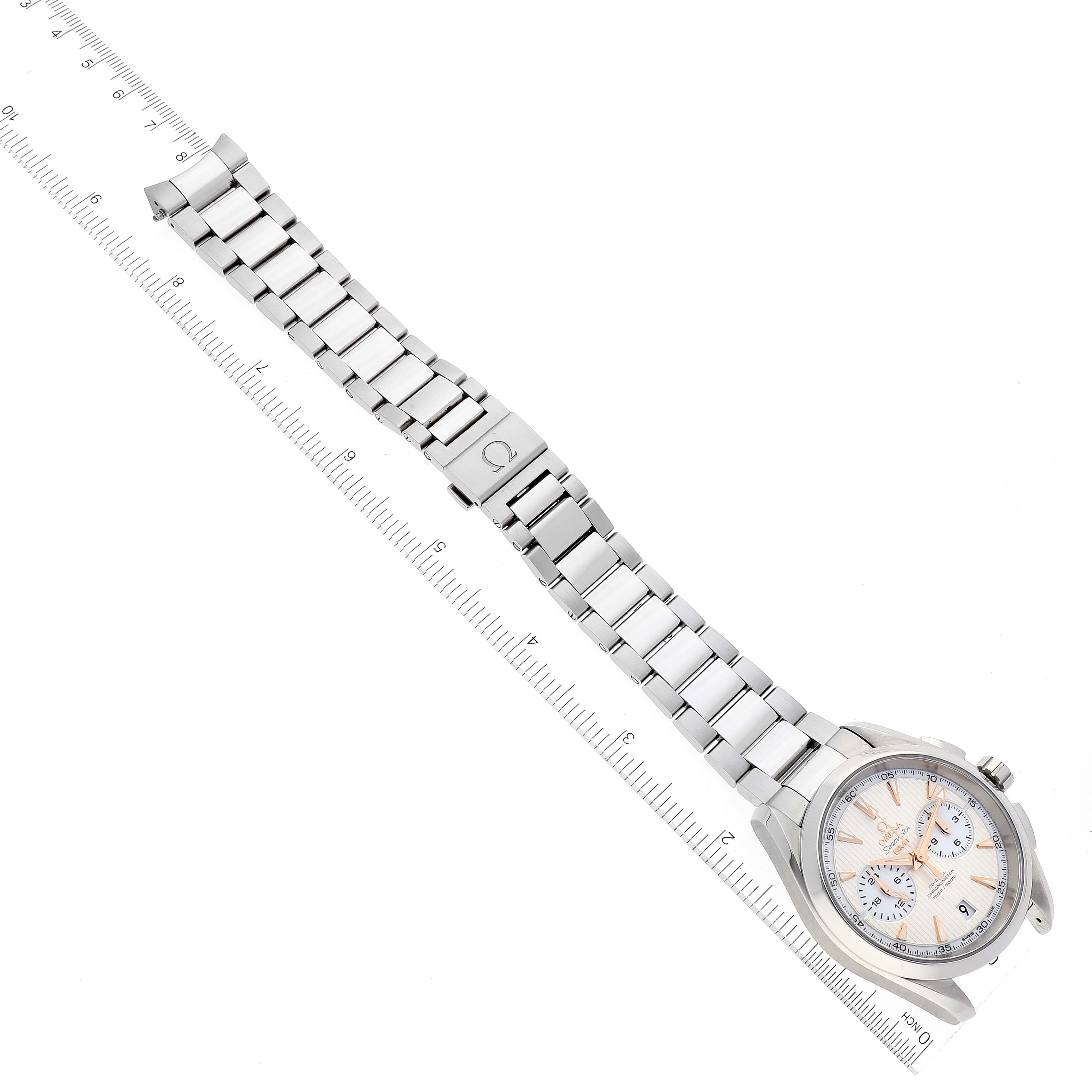 The image shows an Omega Aqua Terra 231.10.43.52.02.001 Men's Stainless Steel Silver Dial 231.10.43.52.02.001 Men's Stainless Steel Silver Dial watch and metal bracelet, laid flat beside a ruler for measurement.