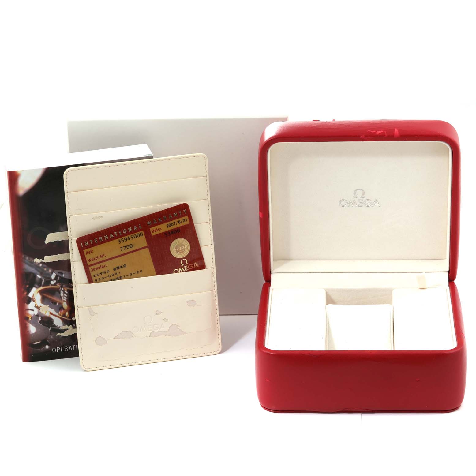 The image shows the accessories for an Omega Speedmaster 3594.50.00 Men
s Stainless Steel Black Dial 3594.50.00 Men
s Stainless Steel Black Dial, including the red box, warranty card, and manual.