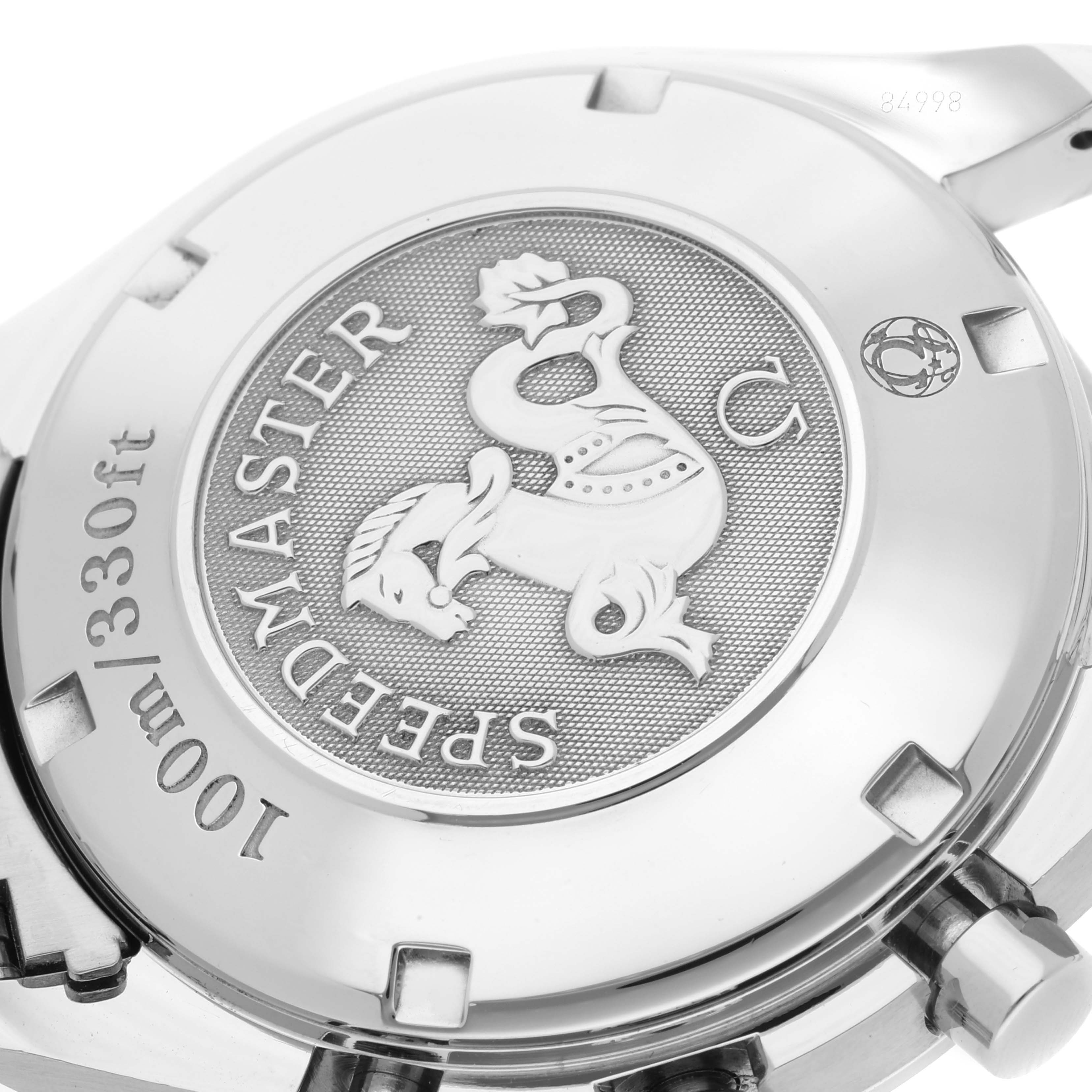 The image shows the engraved case back of an Omega Speedmaster 323.30.40.40.04.001 Men's Stainless Steel White Dial 323.30.40.40.04.001 Men's Stainless Steel White Dial watch viewed from a close-up angle.