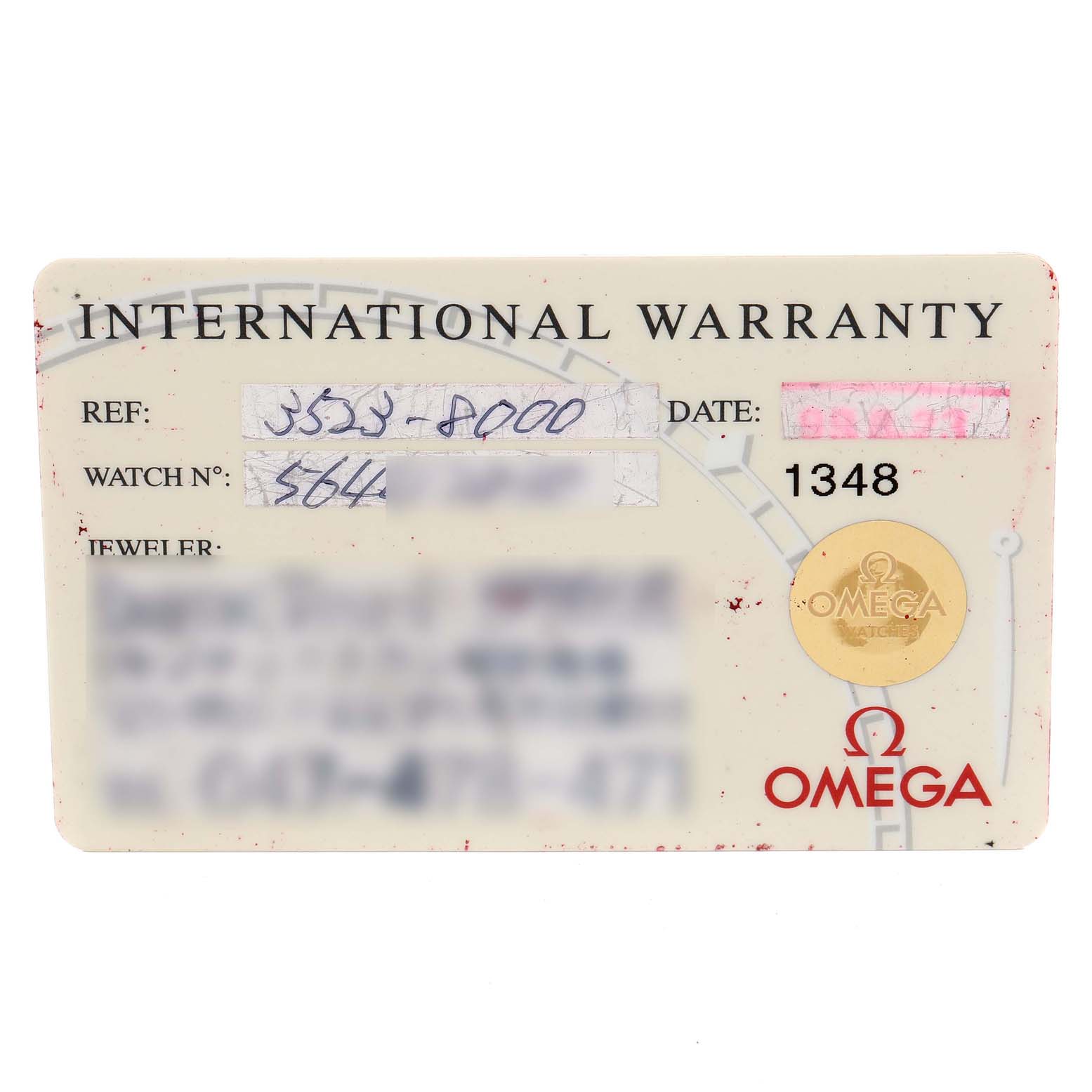 The image shows a close-up of an Omega Speedmaster 3523.80.00 Men's Stainless Steel Blue Dial 3523.80.00 Men's Stainless Steel Blue Dial model's international warranty card.