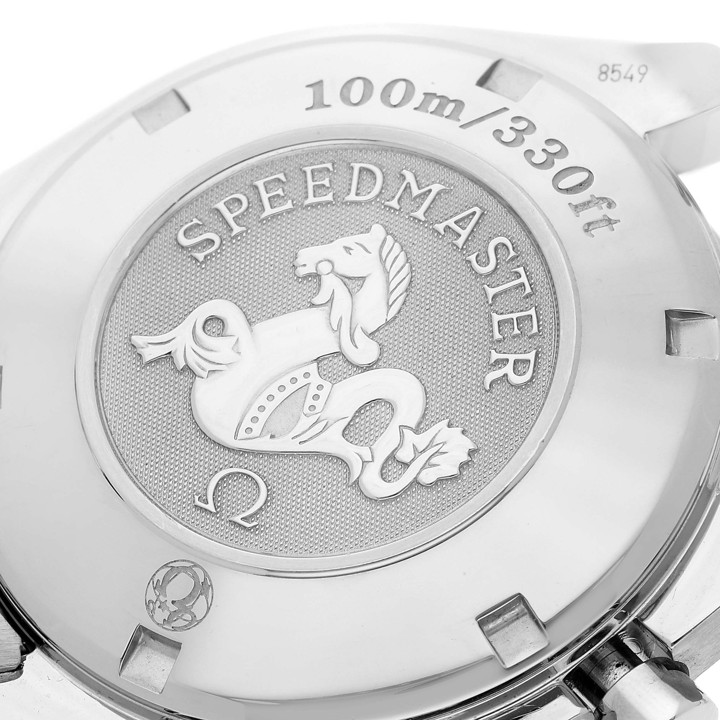 This image shows the back case of an Omega Speedmaster 323.30.40.40.06.001 Men's Stainless Steel Grey Dial 323.30.40.40.06.001 Men's Stainless Steel Grey Dial watch, highlighting the engraved logo and water resistance details.