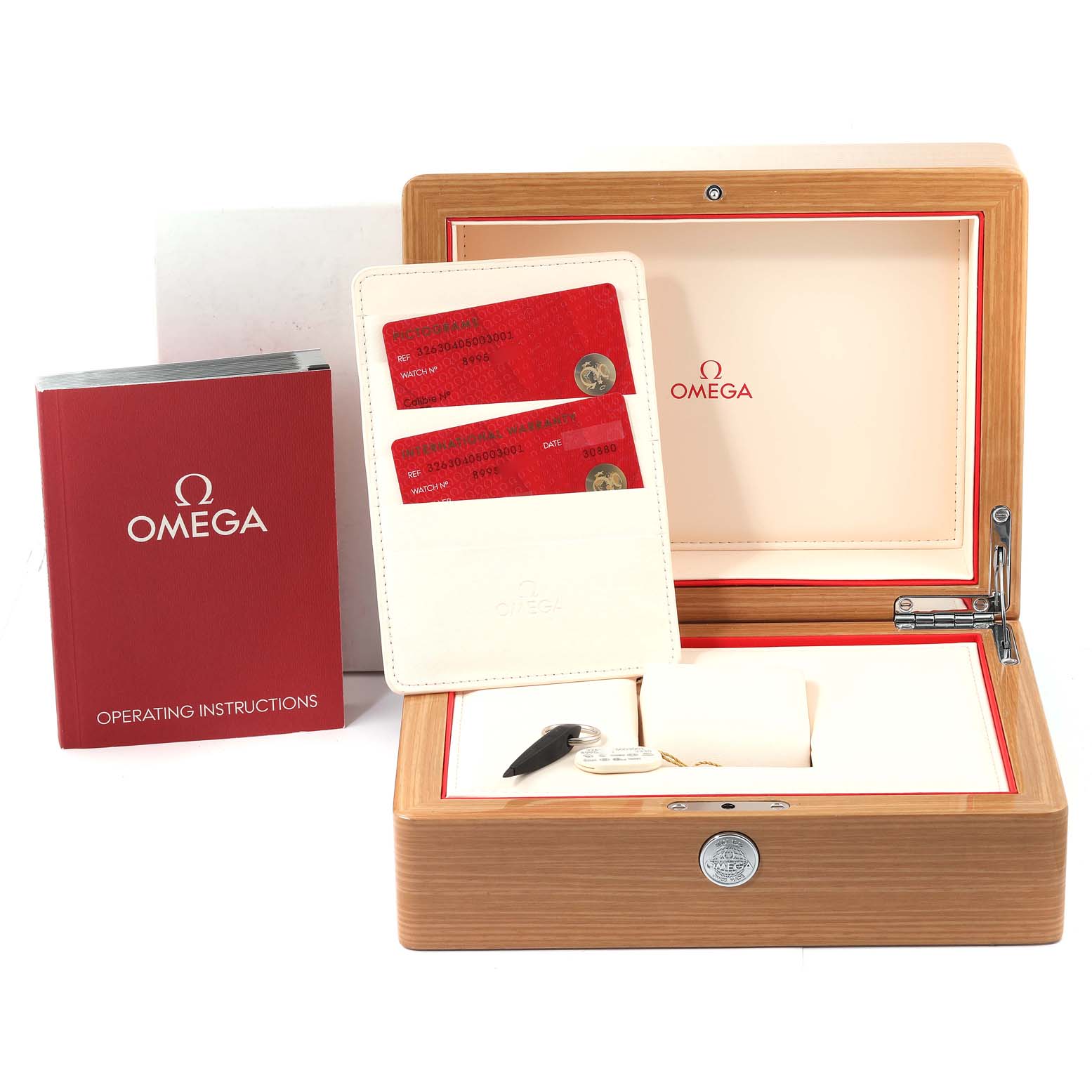 The image shows the Omega Speedmaster 326.30.40.50.03.001 Men's Stainless Steel Blue Dial 326.30.40.50.03.001 Men's Stainless Steel Blue Dial accessories, including the watch box, operating instructions, and warranty cards.