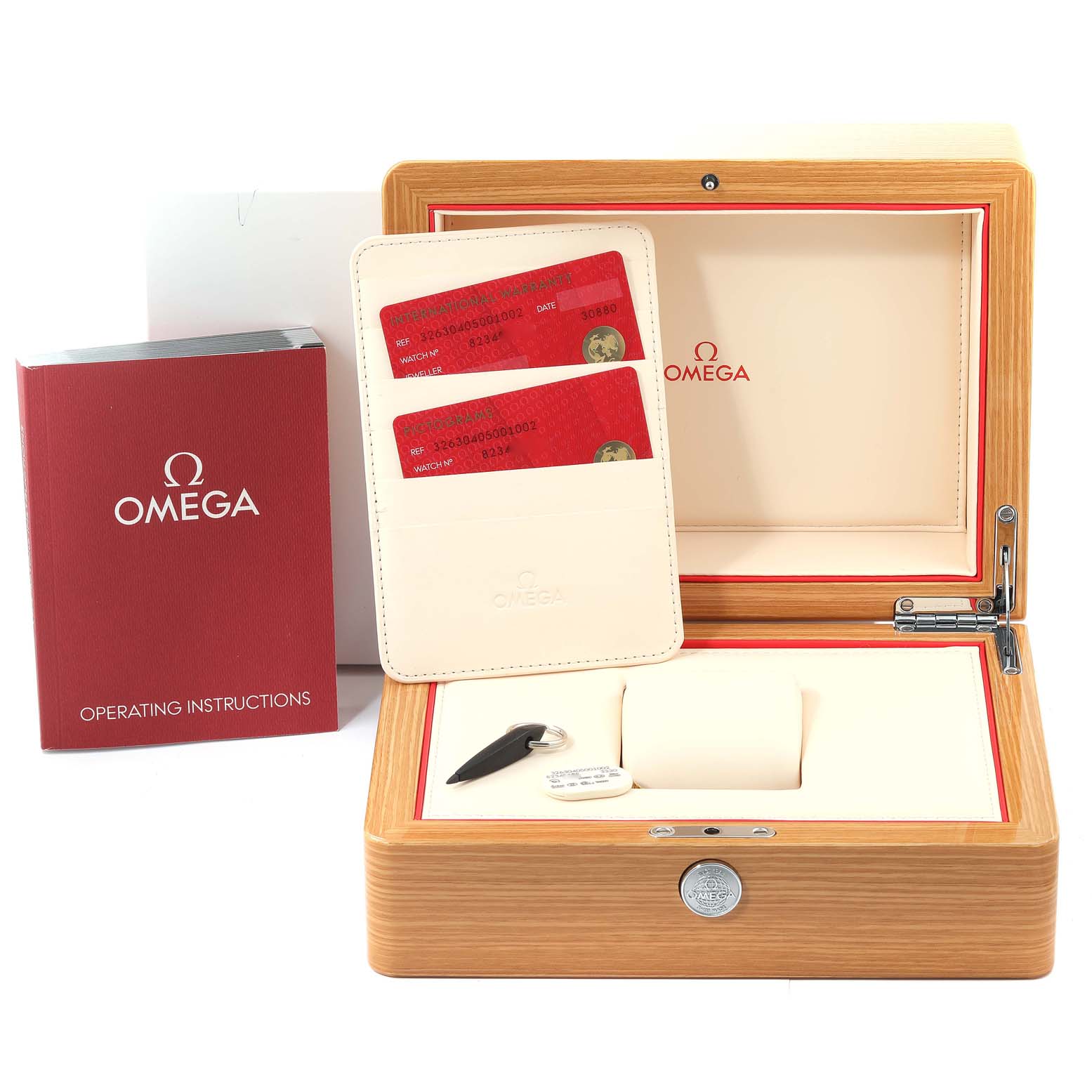The image shows an Omega Speedmaster 326.30.40.50.01.002 Men's Stainless Steel Black Dial 326.30.40.50.01.002 Men's Stainless Steel Black Dial watch box, operating instructions booklet, warranty cards, and a key.