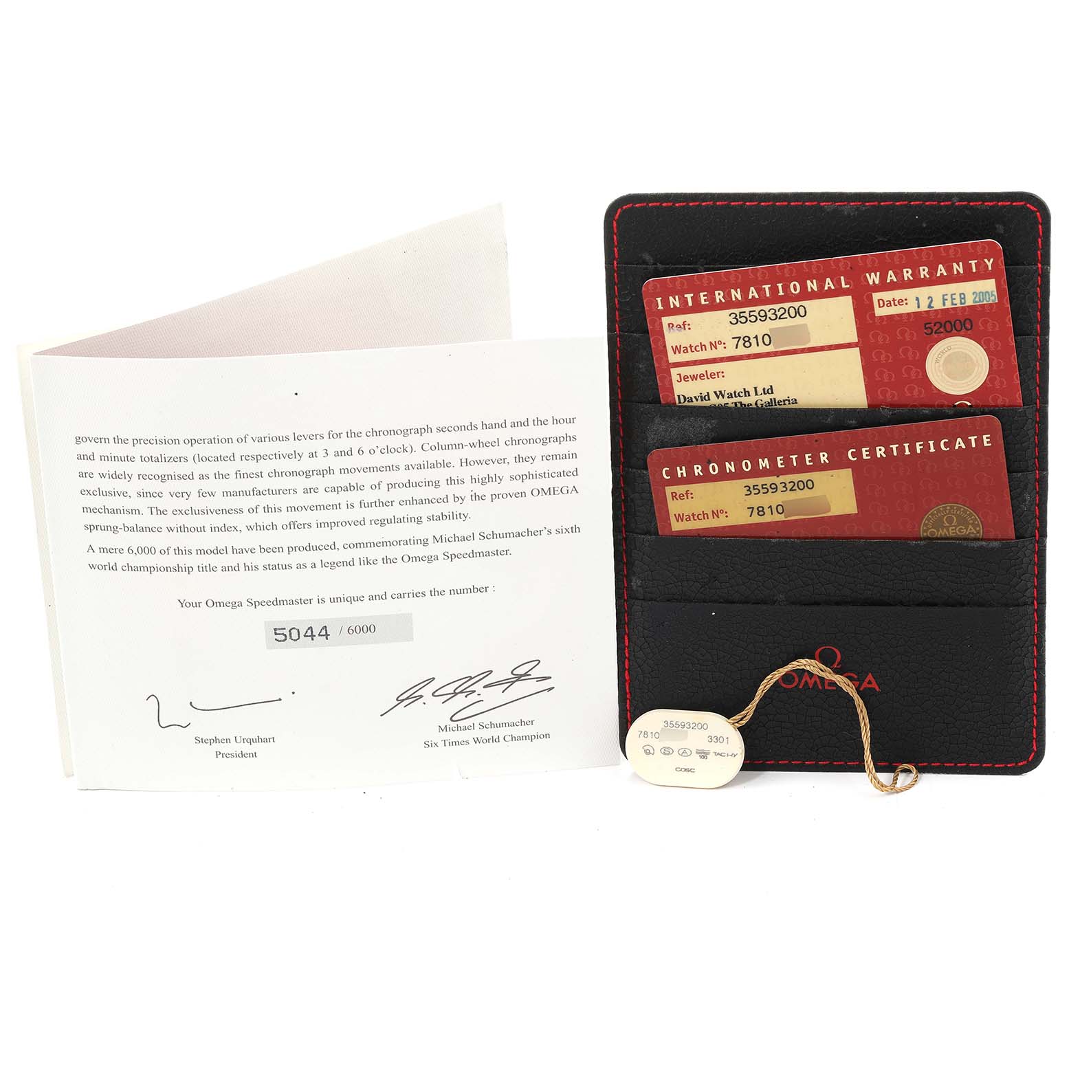 The image shows an Omega Speedmaster 3559.32.00 Men's Stainless Steel Silver Dial 3559.32.00 Men's Stainless Steel Silver Dial warranty and chronometer certificate cards along with a booklet and a holder.