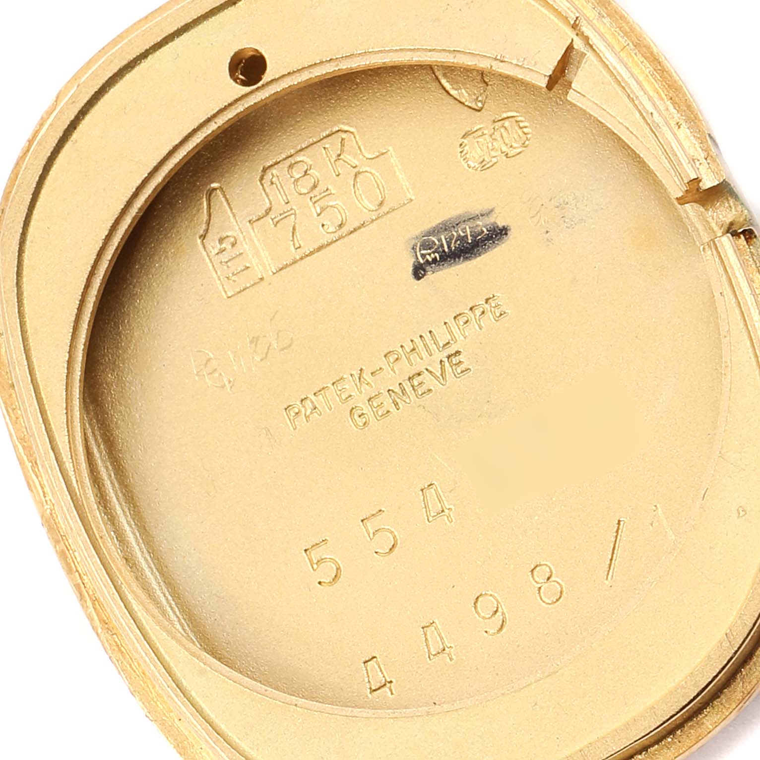 This image shows the inside case back of the Patek Philippe Golden Ellipse 4498 Women's Yellow Gold Blue Dial 4498 Women's Yellow Gold Blue Dial watch, displaying its engravings and hallmarks.