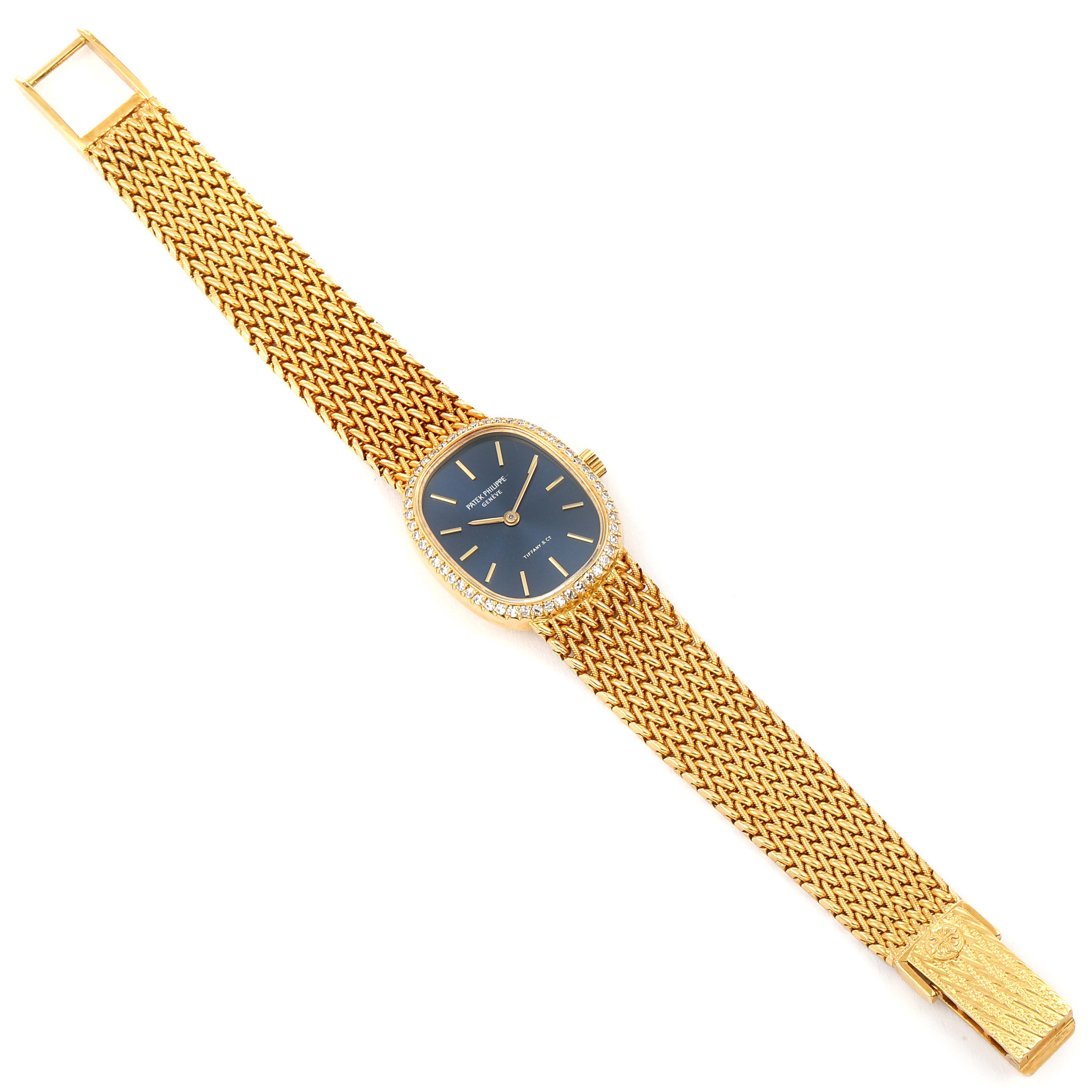 This image shows a Patek Philippe Golden Ellipse 4498 Women's Yellow Gold Blue Dial 4498 Women's Yellow Gold Blue Dial watch laid flat, displaying the full bracelet and dial with a slight angle.