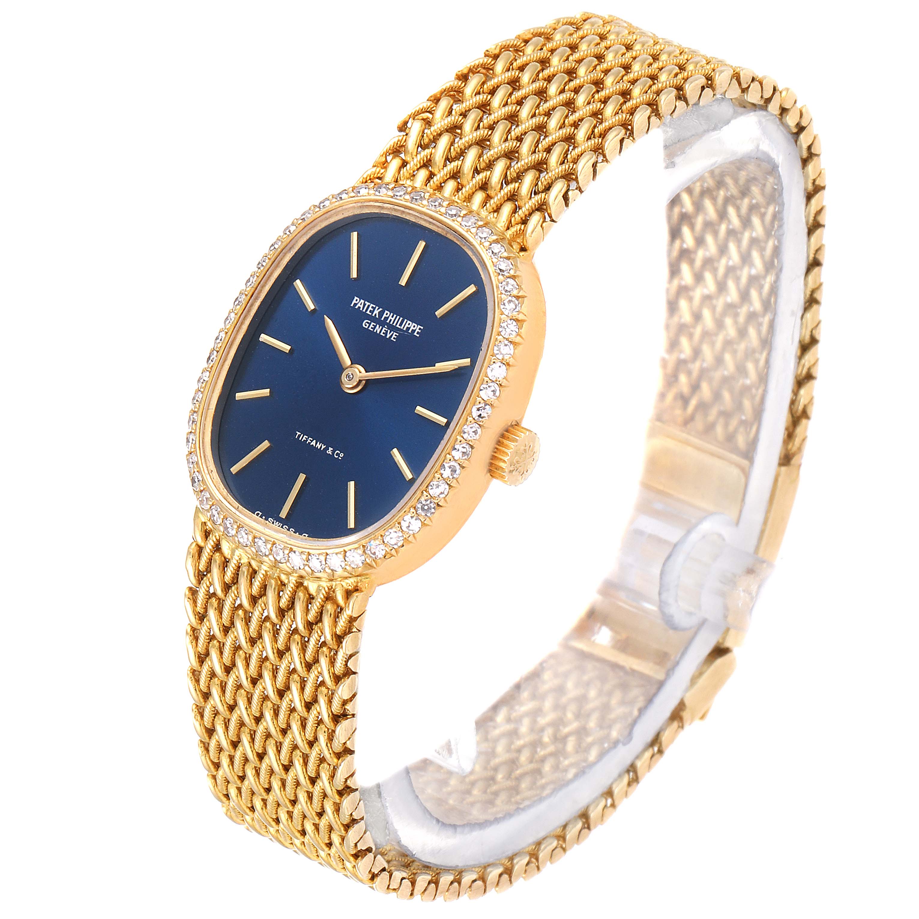The image shows a side angle of the Patek Philippe Golden Ellipse 4498 Women's Yellow Gold Blue Dial 4498 Women's Yellow Gold Blue Dial watch, highlighting its blue dial, gold mesh band, and diamond bezel.