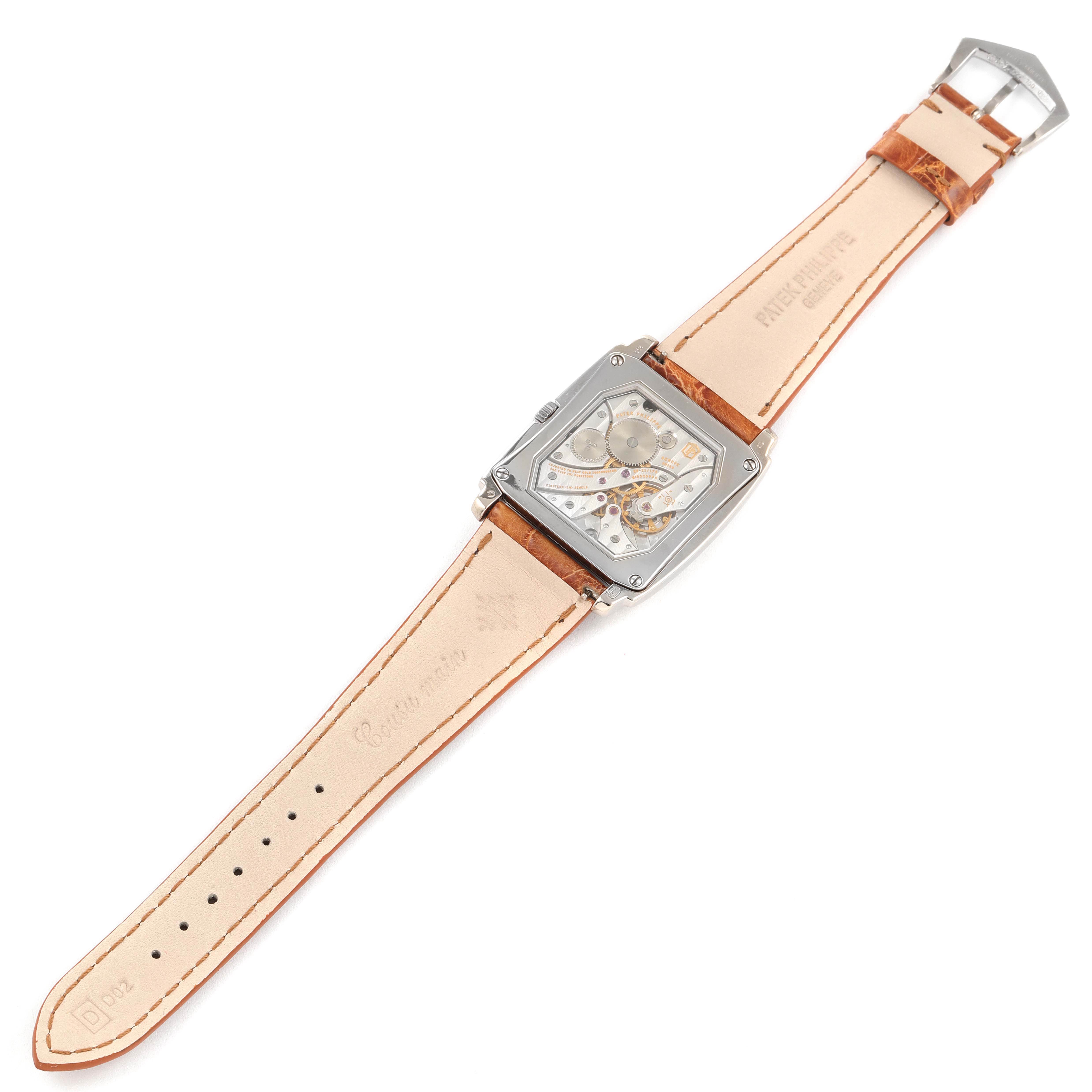 The image shows a Patek Philippe Gondolo 5124G-001 Men's White Gold Pink Dial 5124G-001 Men's White Gold Pink Dial model watch from the back, displaying its movement and leather strap.