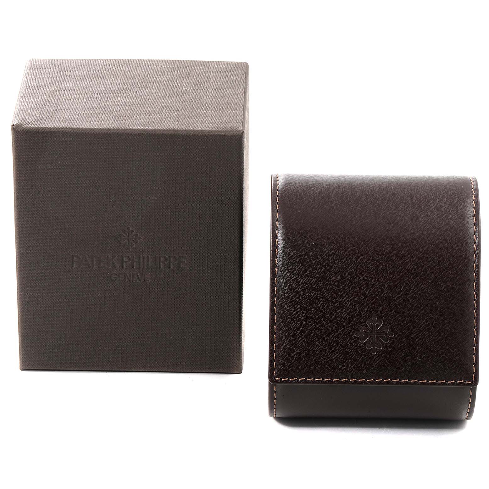 The image shows a boxed case and a leather pouch for the Nautilus model by Patek Philippe from a front angle.