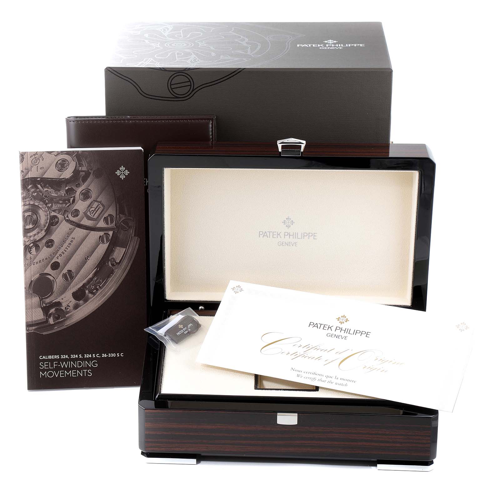 The Patek Philippe Nautilus 7118/1A -011 Men's Stainless Steel Grey Dial 7118/1A -011 Men's Stainless Steel Grey Dial watch accessories are displayed, including the box, certificate, booklet, and a small component.