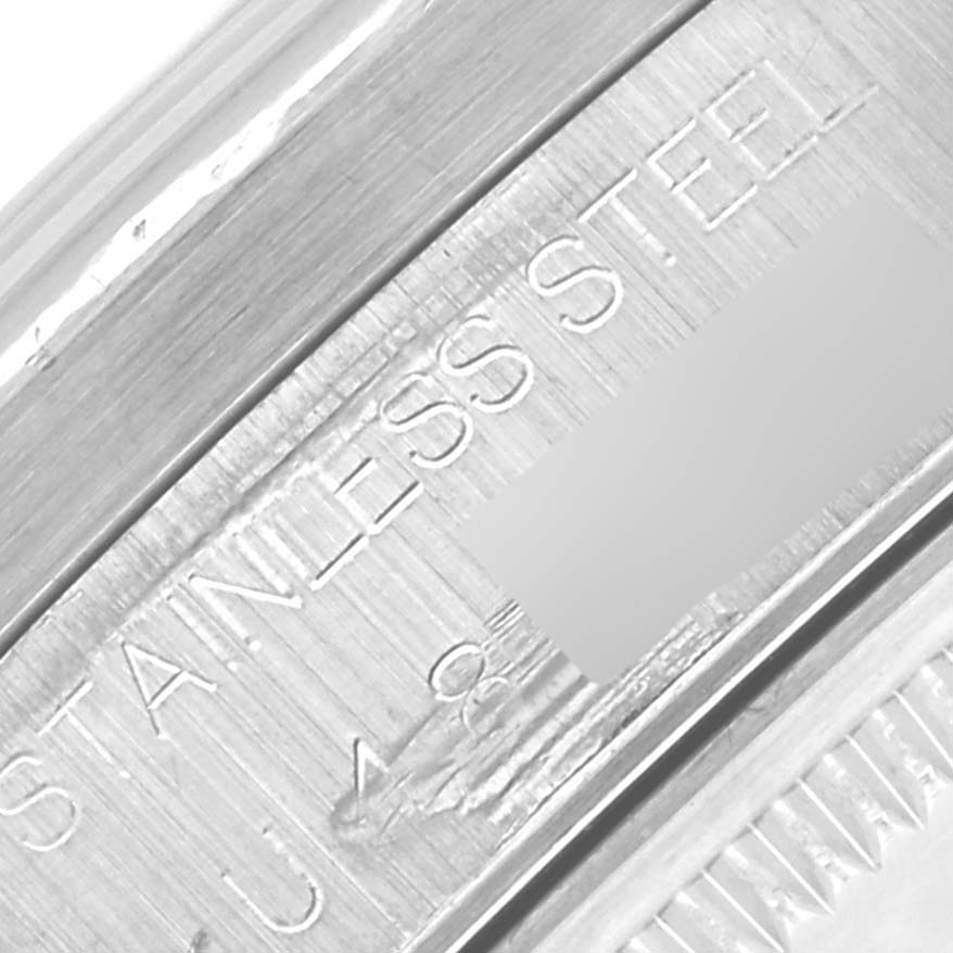 The image shows a close-up of the Rolex Air-King 14010 Men's Stainless Steel Blue Dial 14010 Men's Stainless Steel Blue Dial's stainless steel case with engraved text.