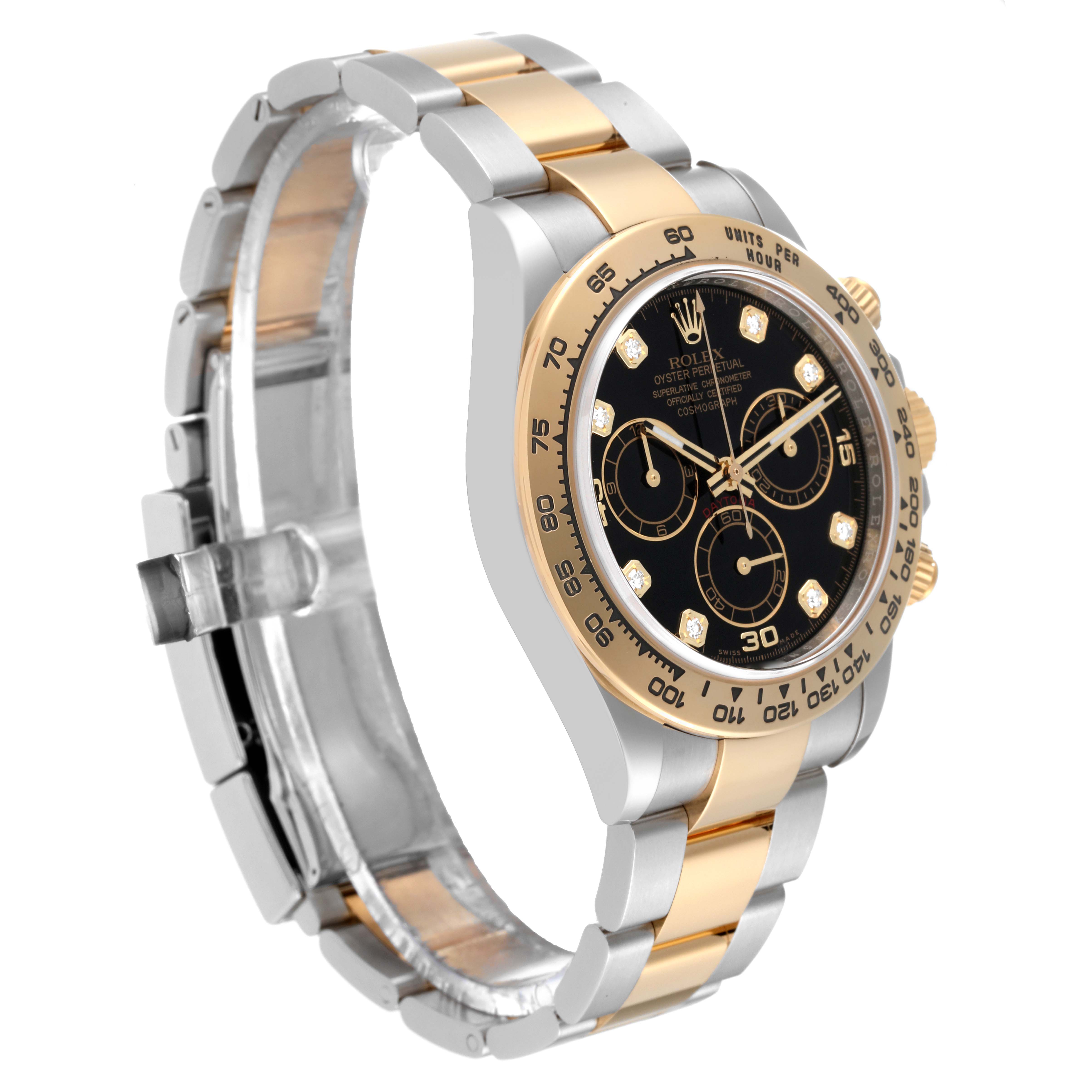 The image shows a Rolex Daytona 116503 Men
s Steel and Gold (two tone) Black Dial 116503 Men
s Steel and Gold (two tone) Black Dial watch at an angle that displays its black dial, gold bezel, and two-tone bracelet.