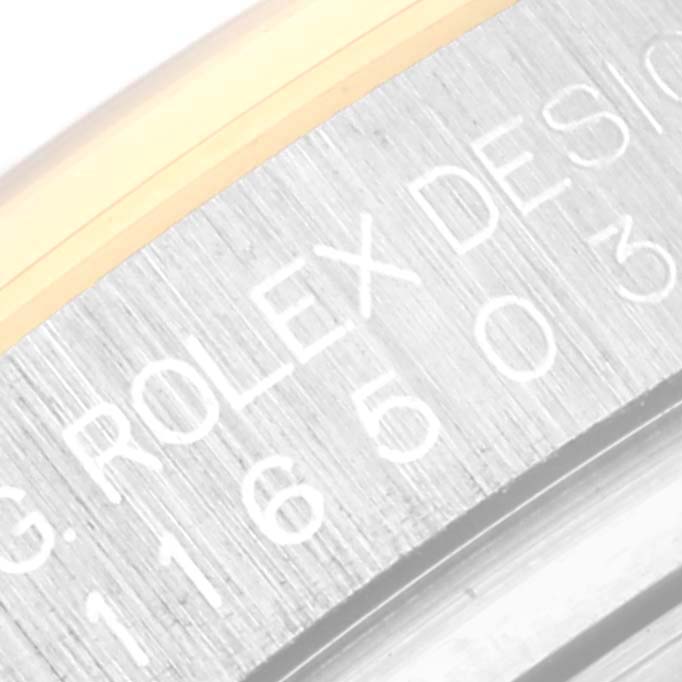 This close-up angle shows the engraved model number and "Rolex Design" on the casing of the Rolex Daytona 116503 Men
s Steel and Gold (two tone) Black Dial 116503 Men
s Steel and Gold (two tone) Black Dial watch.