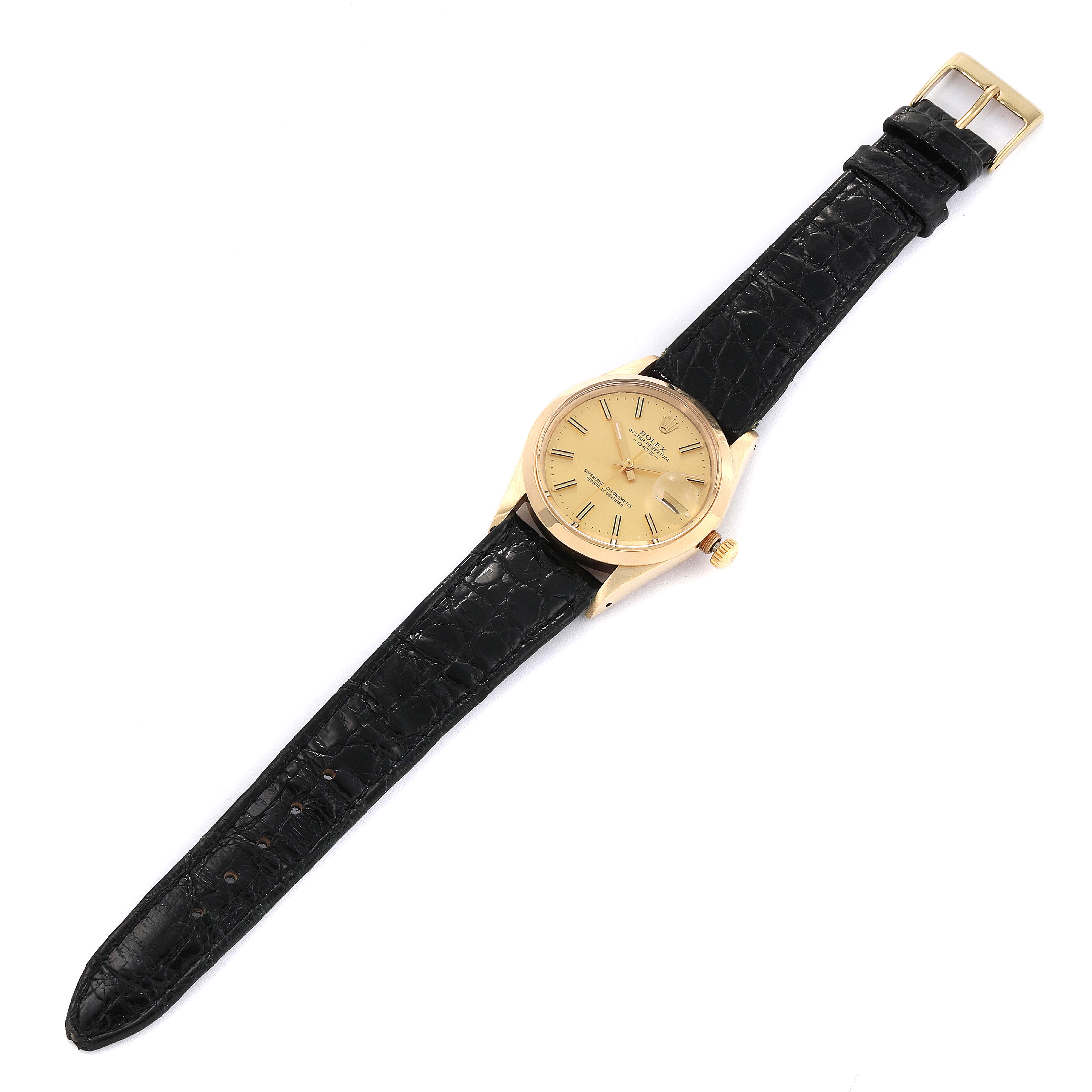 The image shows a top view of a Rolex Vintage Collection 15007 Men's Yellow Gold Champagne Dial 15007 Men's Yellow Gold Champagne Dial watch featuring a gold dial and black leather strap.