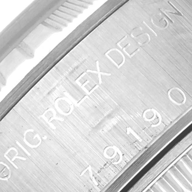 The image shows a close-up of the engraved side of a Rolex Date 79190 Women's Stainless Steel Pink Dial 79190 Women's Stainless Steel Pink Dial model, featuring the serial and design markings.