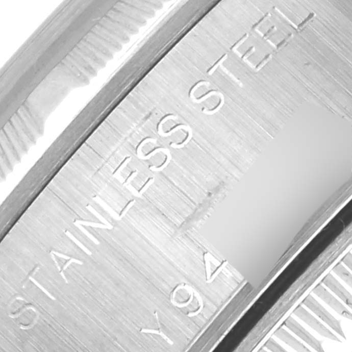 The image shows a close-up angle of the Rolex Date 79190 Women's Stainless Steel Pink Dial 79190 Women's Stainless Steel Pink Dial model's watch case, focusing on the "Stainless Steel" engraving.