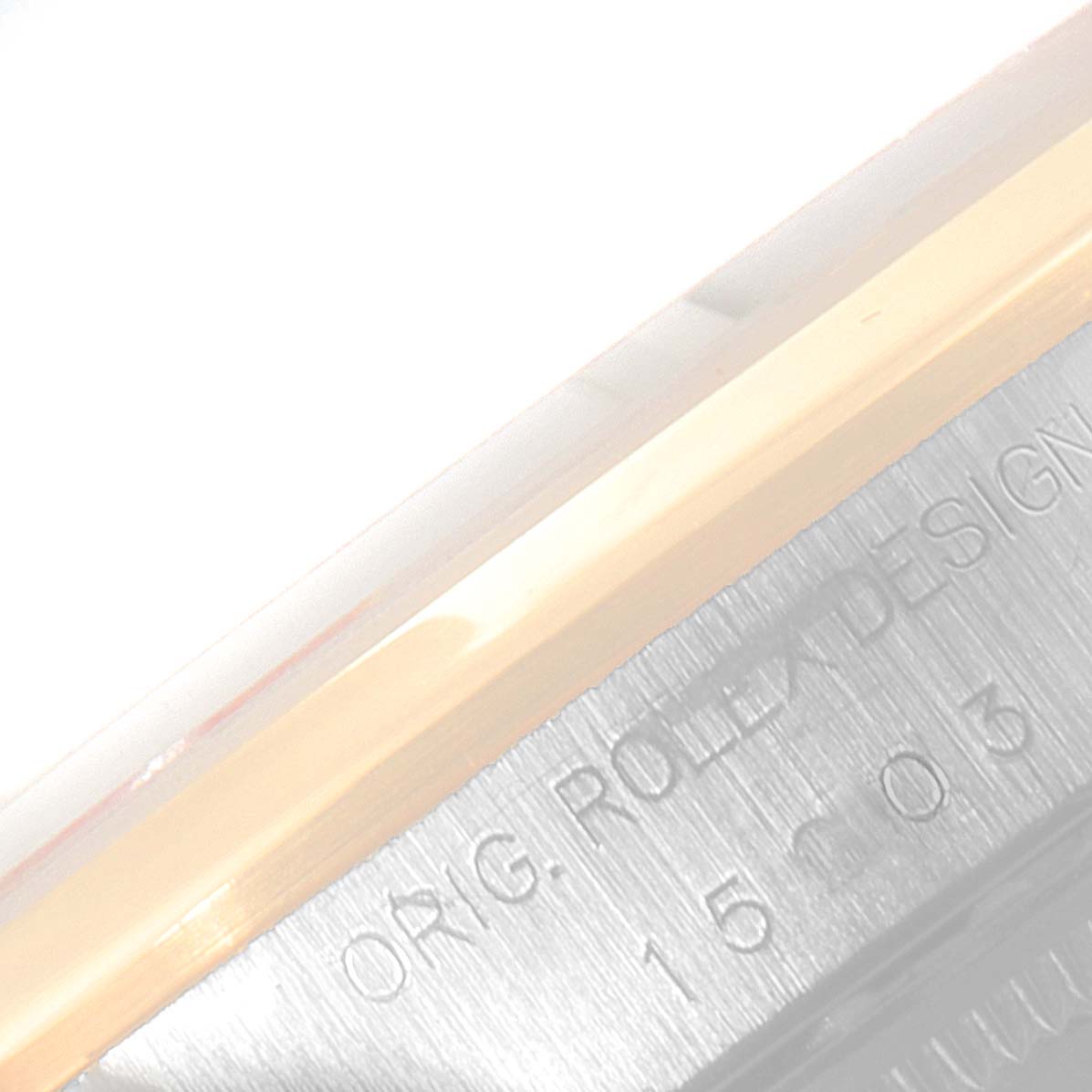 This image shows a close-up of the side edge of the case back of a Rolex Date 15203 Men's Steel and Gold (two tone) Silver Dial 15203 Men's Steel and Gold (two tone) Silver Dial model watch, highlighting the engraved text.