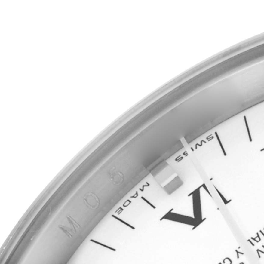 The image shows a close-up of the Rolex Date 115200 Men's Stainless Steel White Dial 115200 Men's Stainless Steel White Dial model, focusing on part of the dial with Roman numerals and bezel.