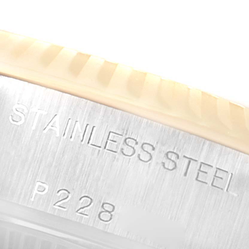 The image shows a close-up of the stainless steel case with the edge of the bezel of a Rolex Datejust 79173 Women's Steel and Gold (two tone) White Dial 79173 Women's Steel and Gold (two tone) White Dial watch.