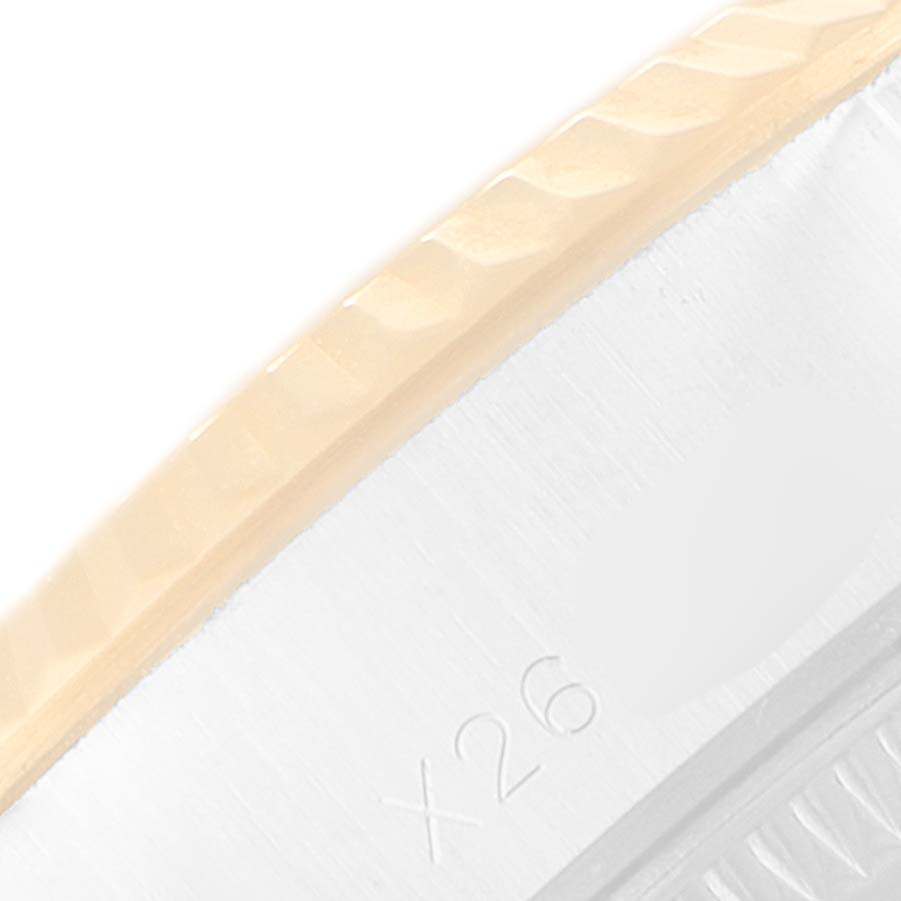 The image shows a close-up of the fluted bezel and part of the case of a Rolex Datejust 69173 Women
s Steel and Gold (two tone) Silver Dial 69173 Women
s Steel and Gold (two tone) Silver Dial watch.