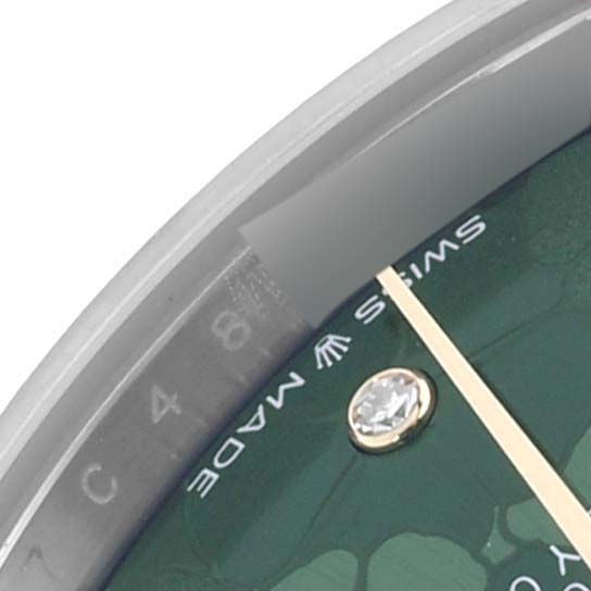The image shows a close-up of the dial and bezel of a Rolex Mid-Size 278273 Women's Steel and Gold (two tone) Green Dial 278273 Women's Steel and Gold (two tone) Green Dial watch, highlighting a diamond marker and the "Swiss Made" text.