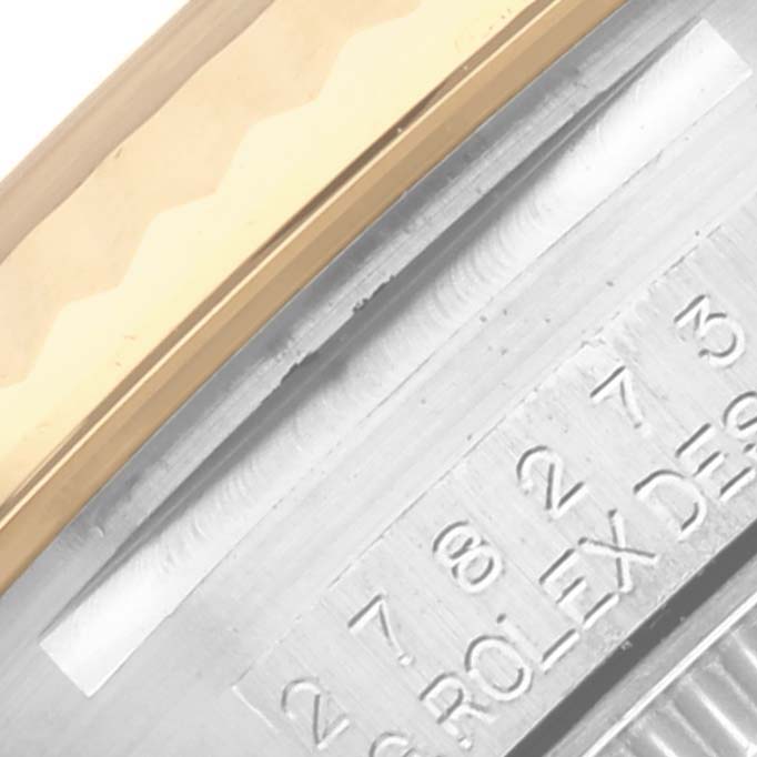 The image shows the side view of a Rolex Mid-Size 278273 Women's Steel and Gold (two tone) Green Dial 278273 Women's Steel and Gold (two tone) Green Dial model, focusing on the bezel and engraved details.