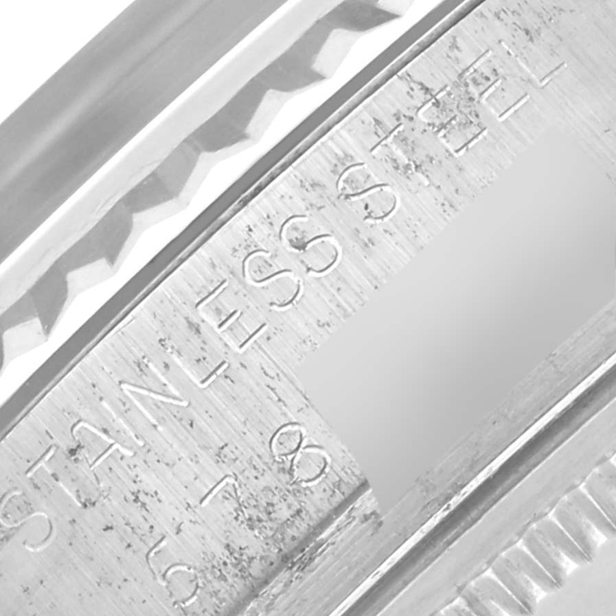 The image shows a close-up side angle of the Rolex Datejust 16014 Men
s Stainless Steel Silver Dial 16014 Men
s Stainless Steel Silver Dial model, highlighting part of the case and engraved details.